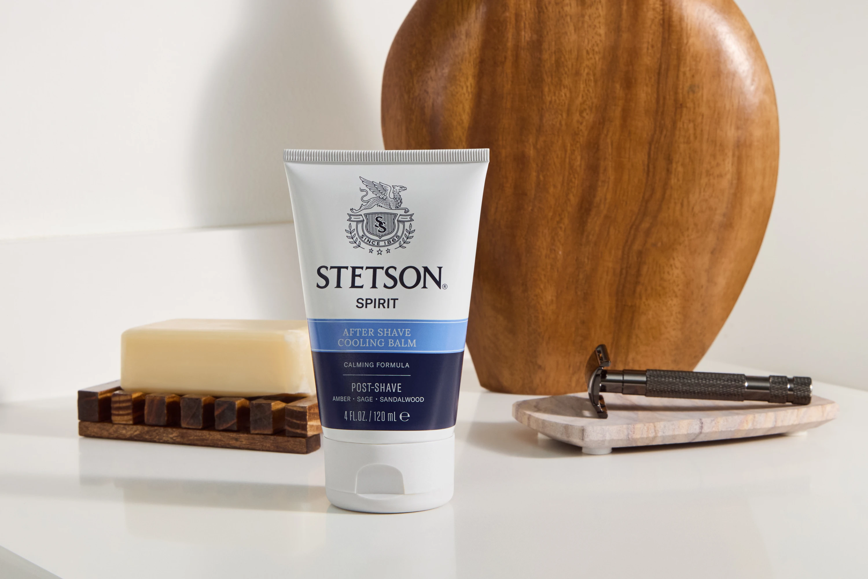 A Stetson tube with a wooden bowl and grooming tools.