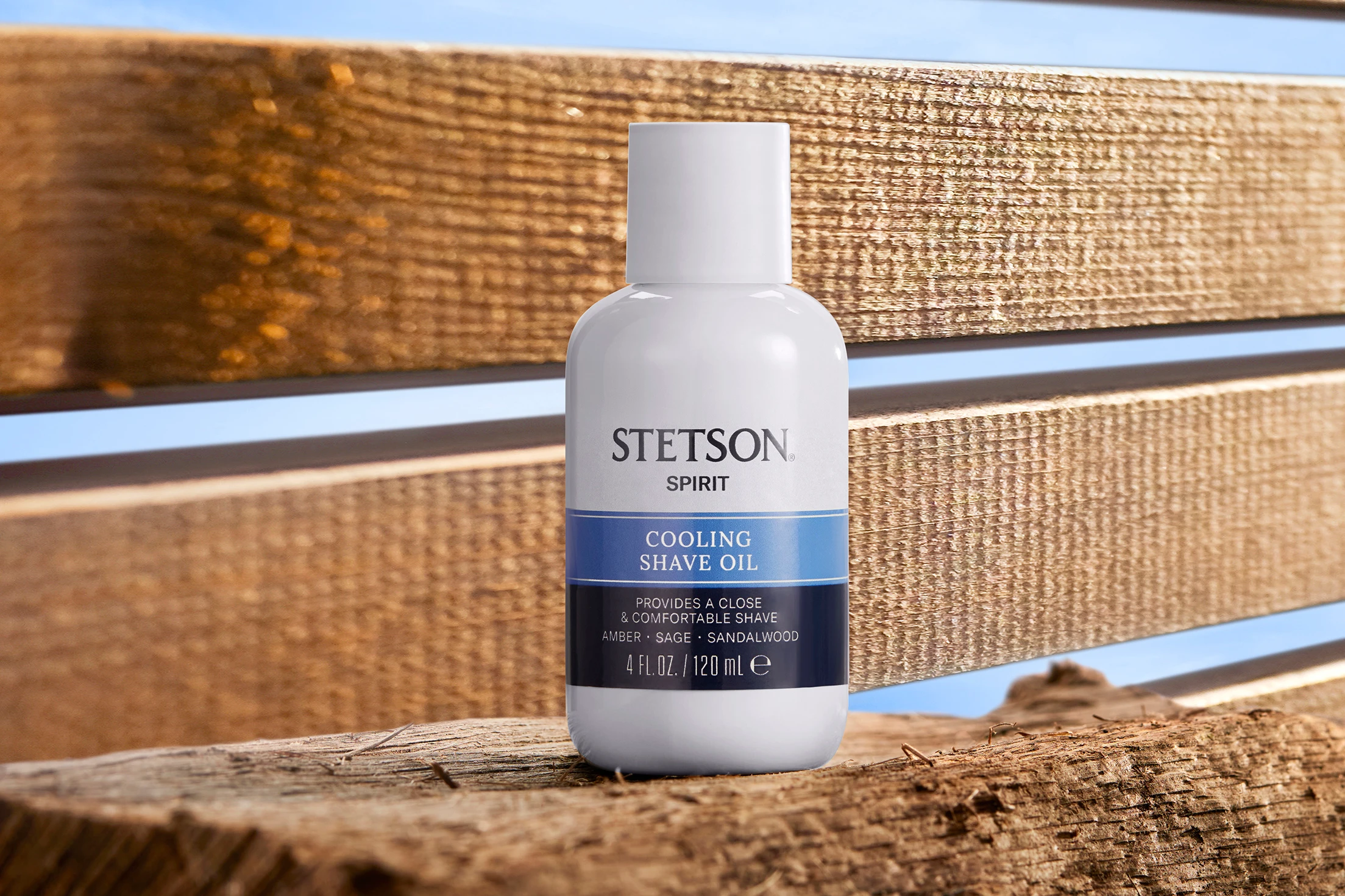 A Stetson bottle displayed on weathered wood.
