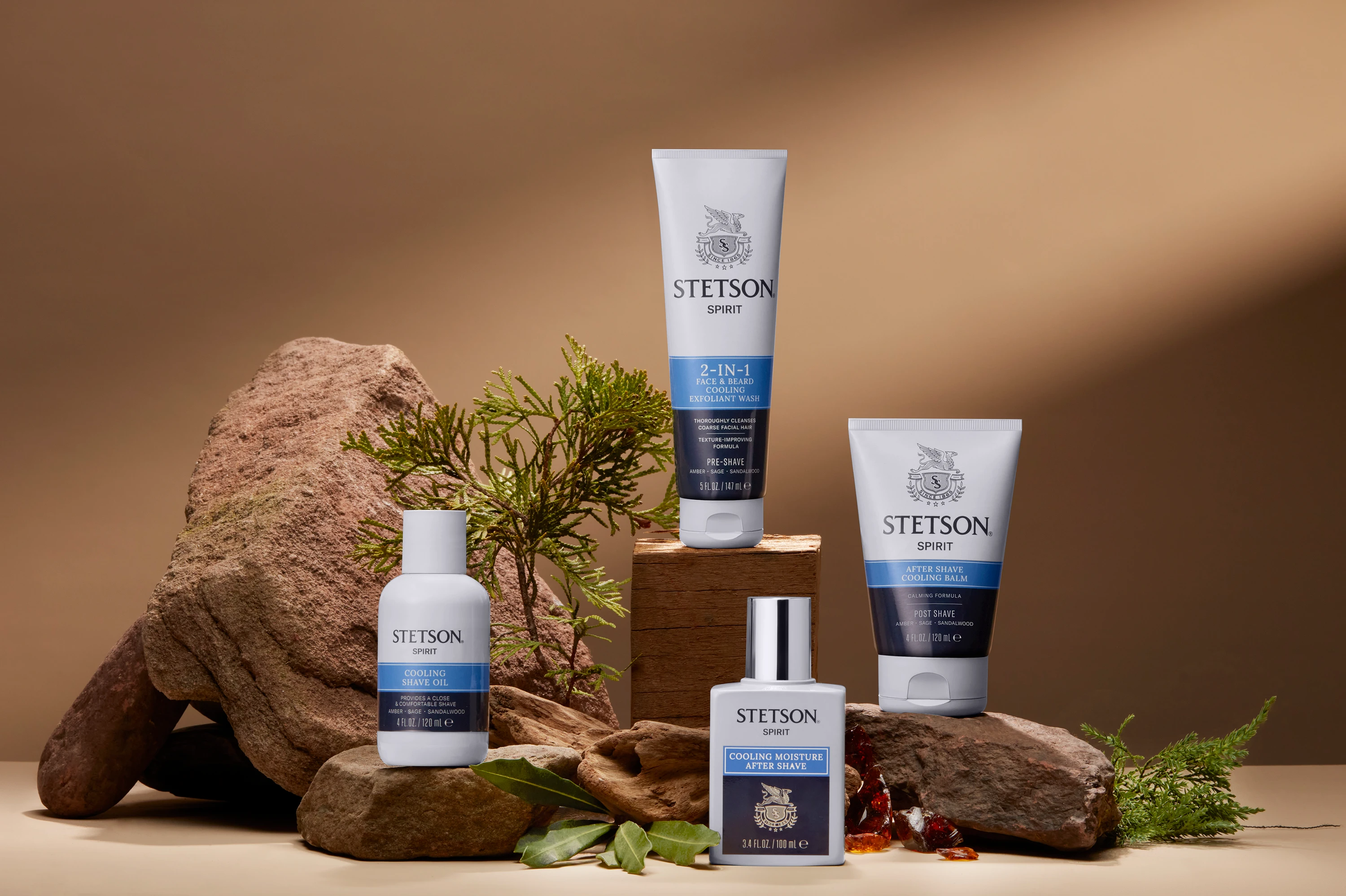 Stetson grooming products arranged on rocks with greenery.