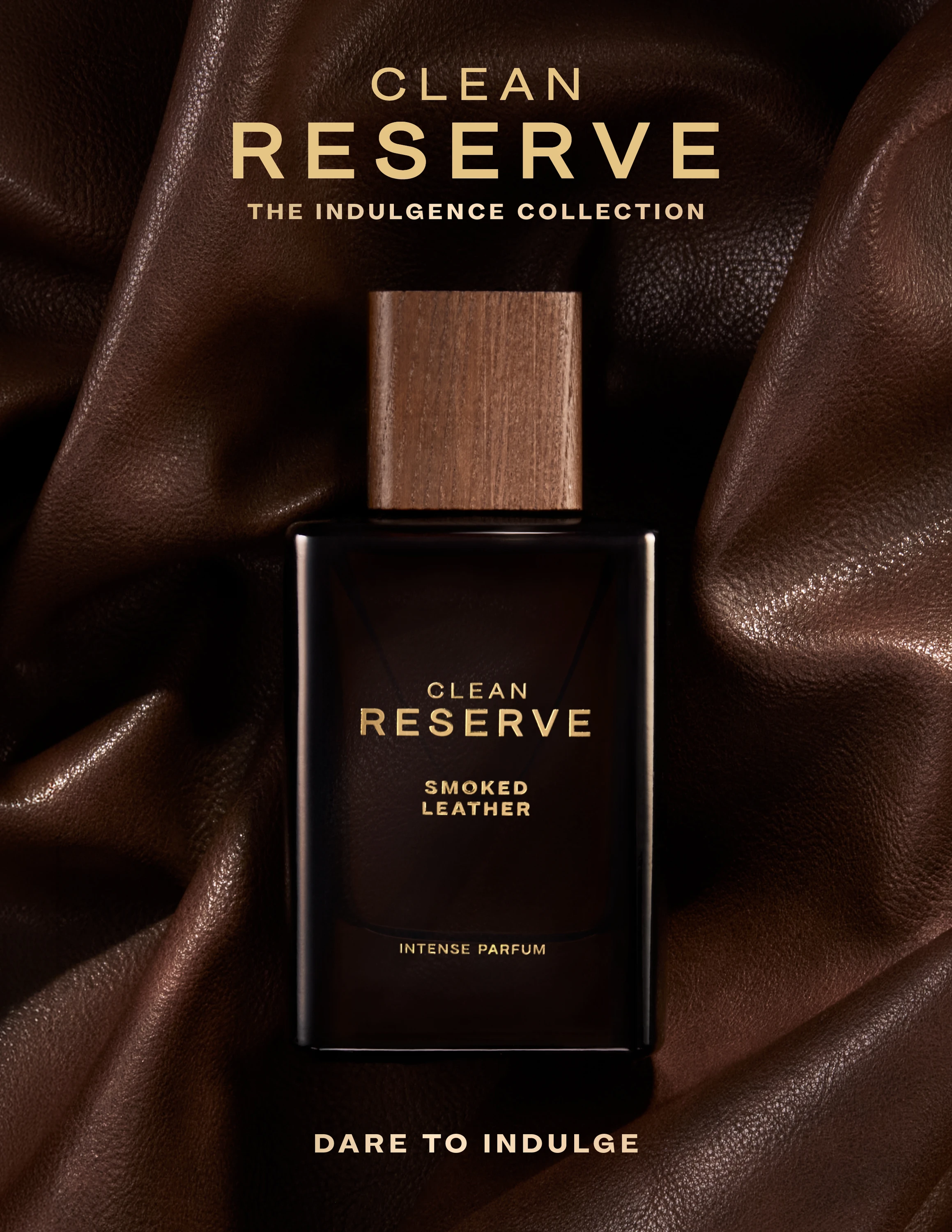 Clean Reserve Indulgence bottle against folded dark fabric.