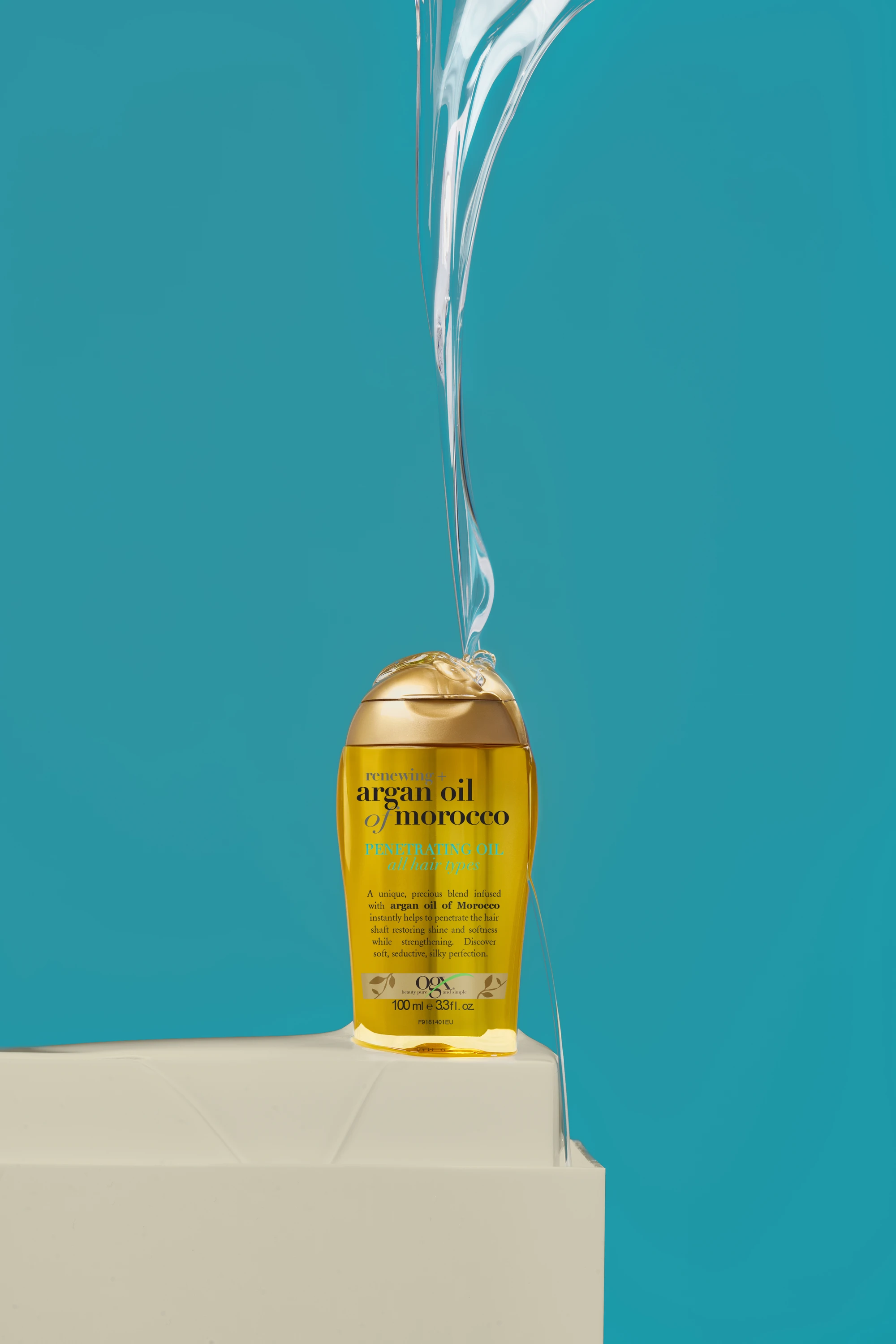 An OGX bottle beneath a stream of liquid.