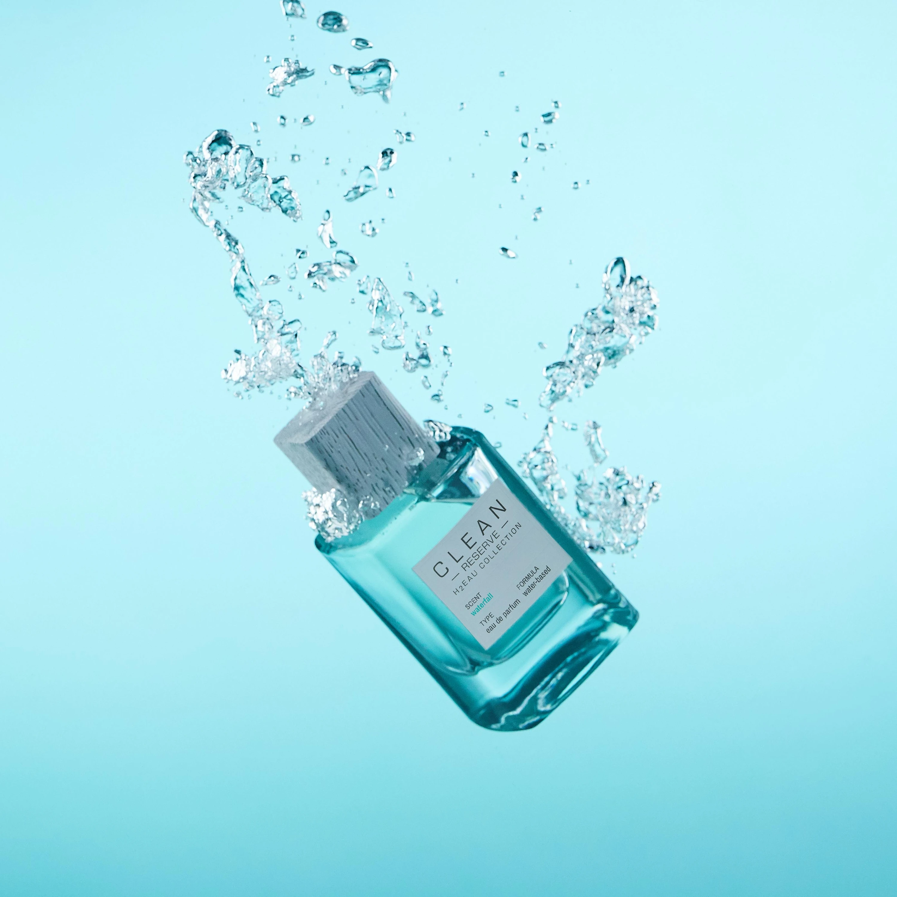 A blue Clean Reserve H2eau bottle amid splashing water.