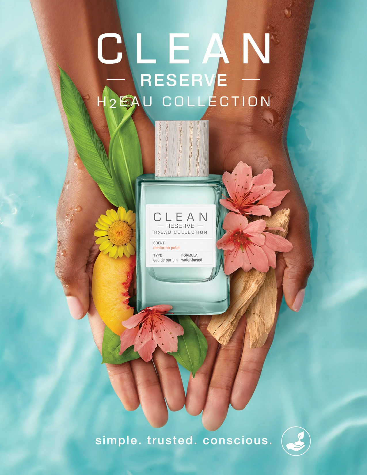 Hands holding a Clean Reserve bottle with pink flowers and green fruit.