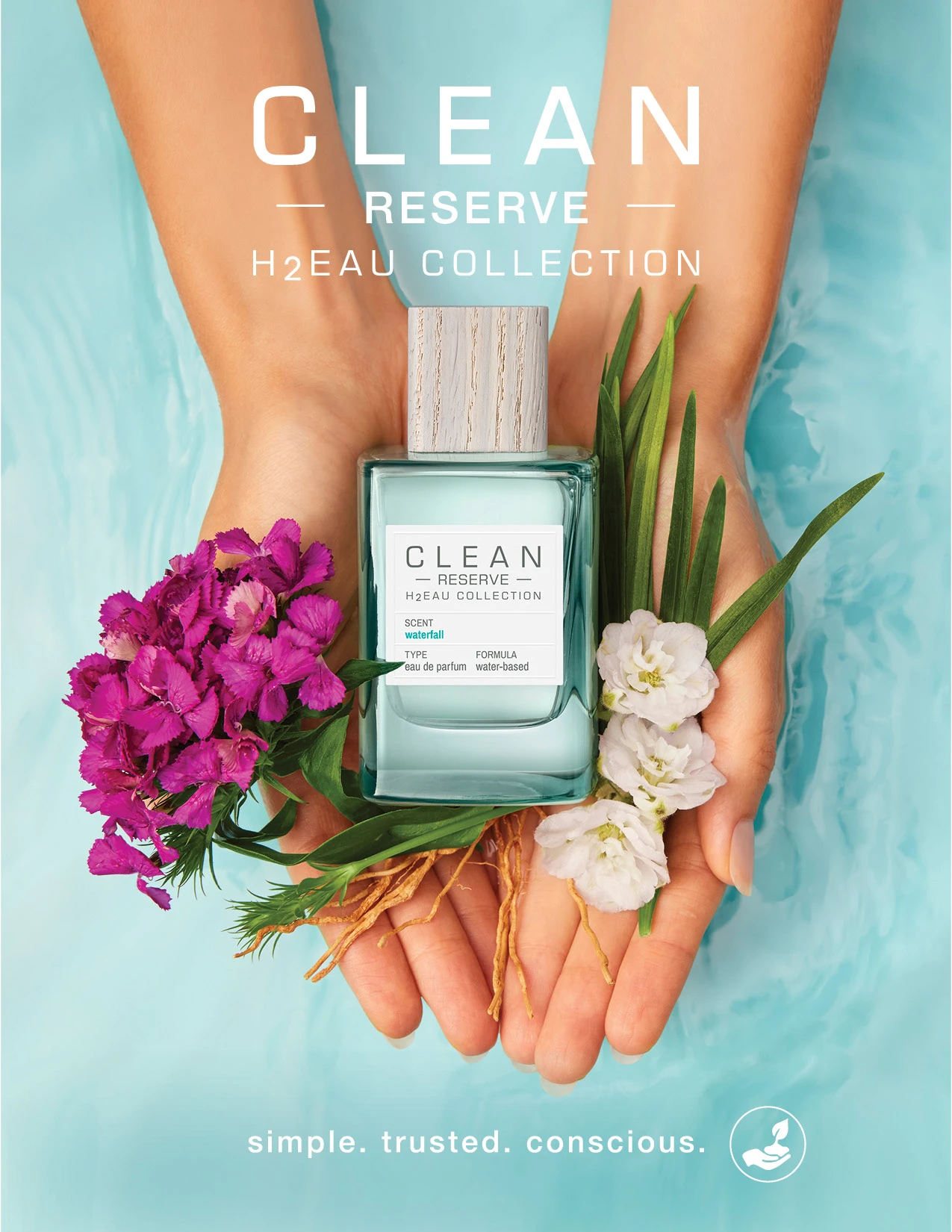 Hands holding a Clean Reserve bottle with purple flowers and greenery.