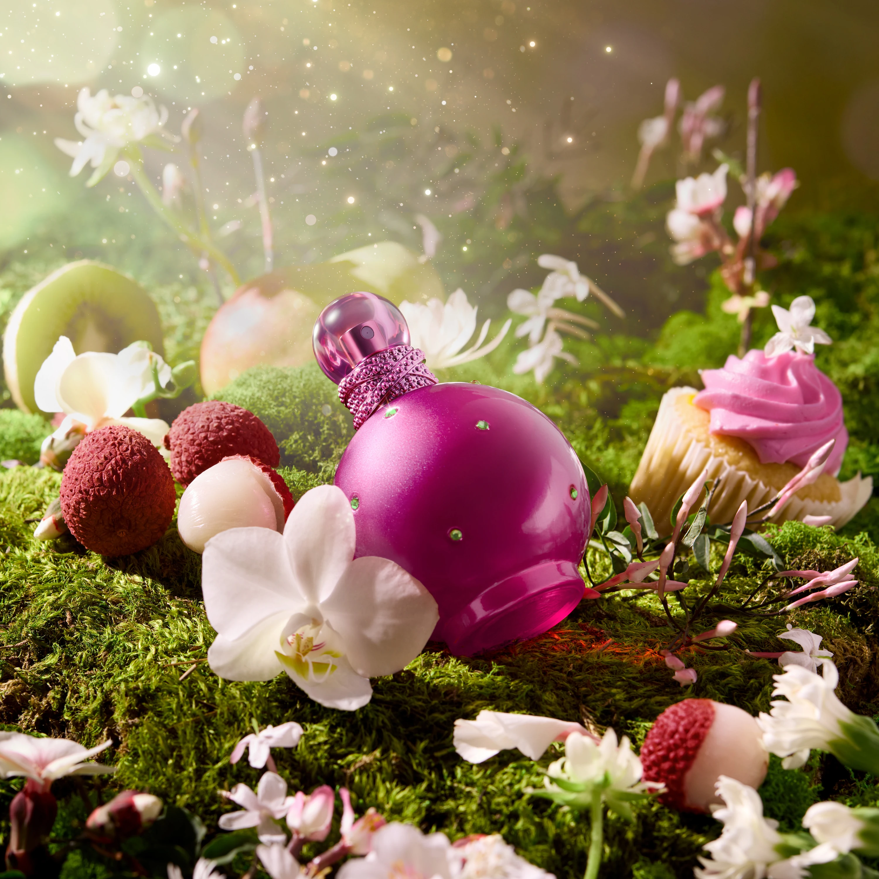 A pink Britney Spears bottle among flowers and fruit.