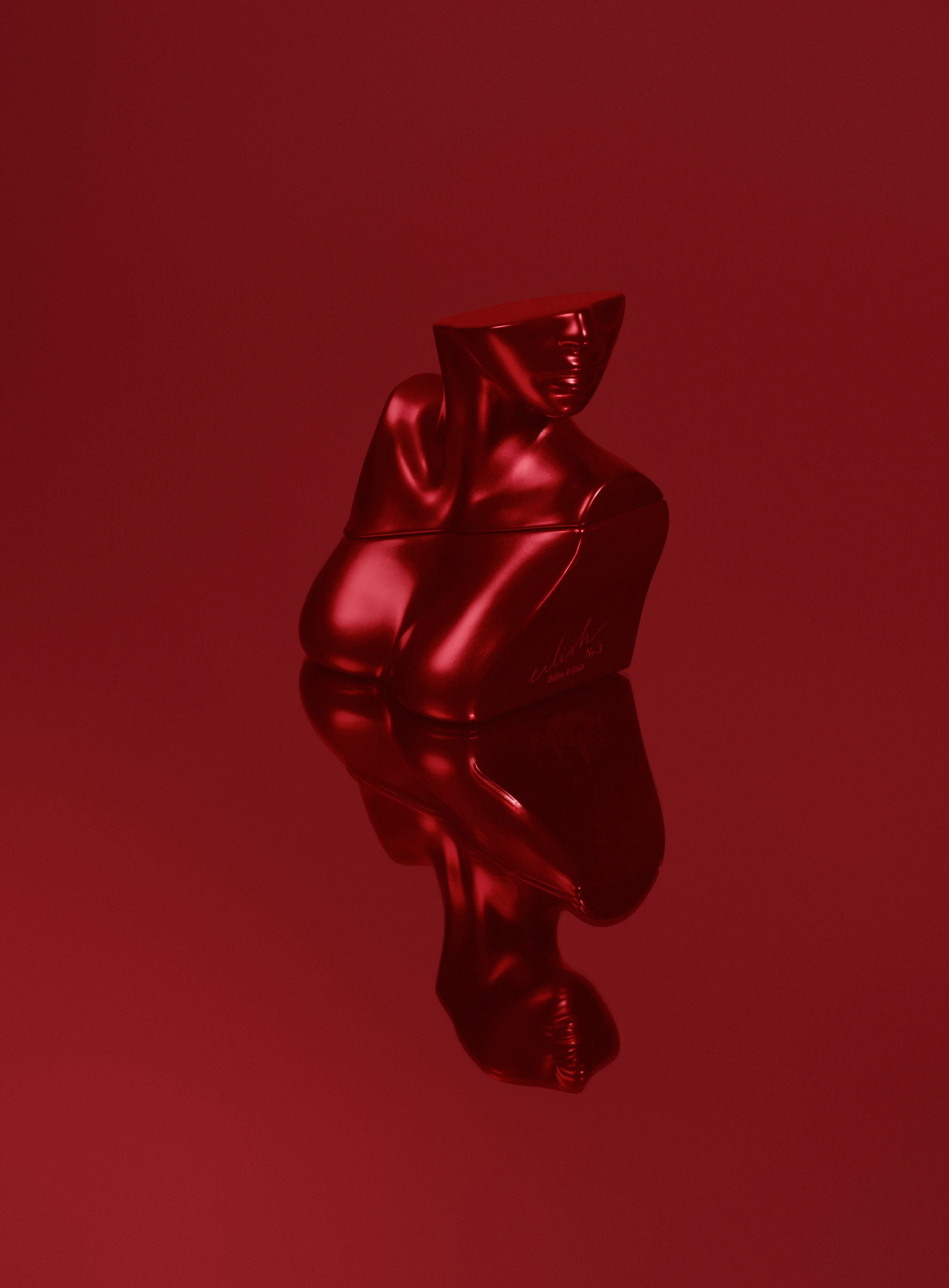 A red sculptural Billie Eilish fragrance bottle against a red background.