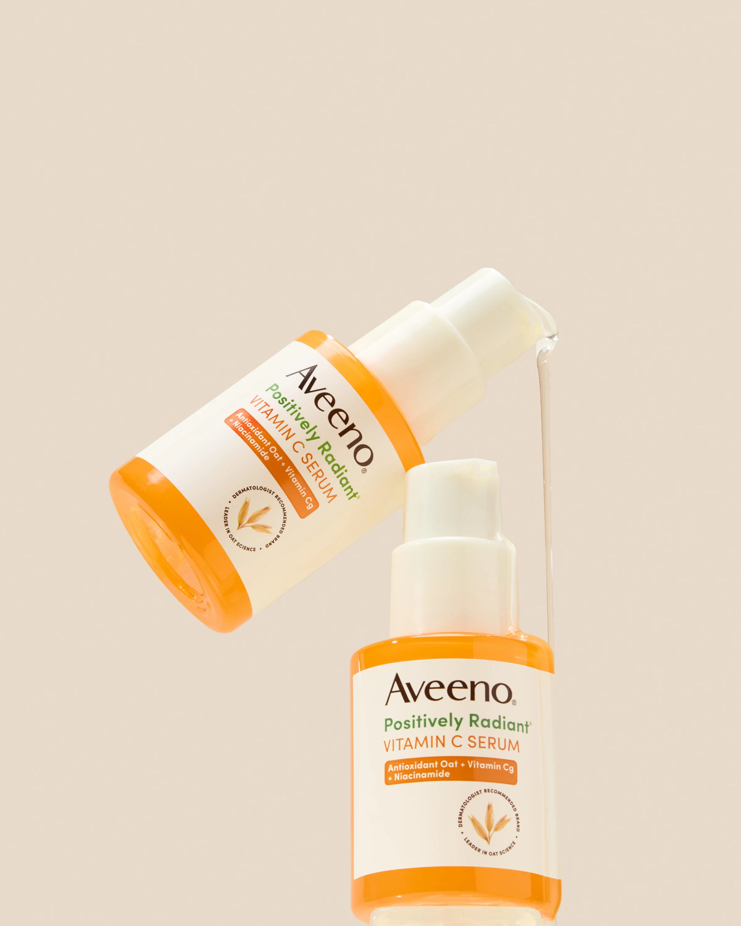 Two Aveeno serum bottles against a pale background.