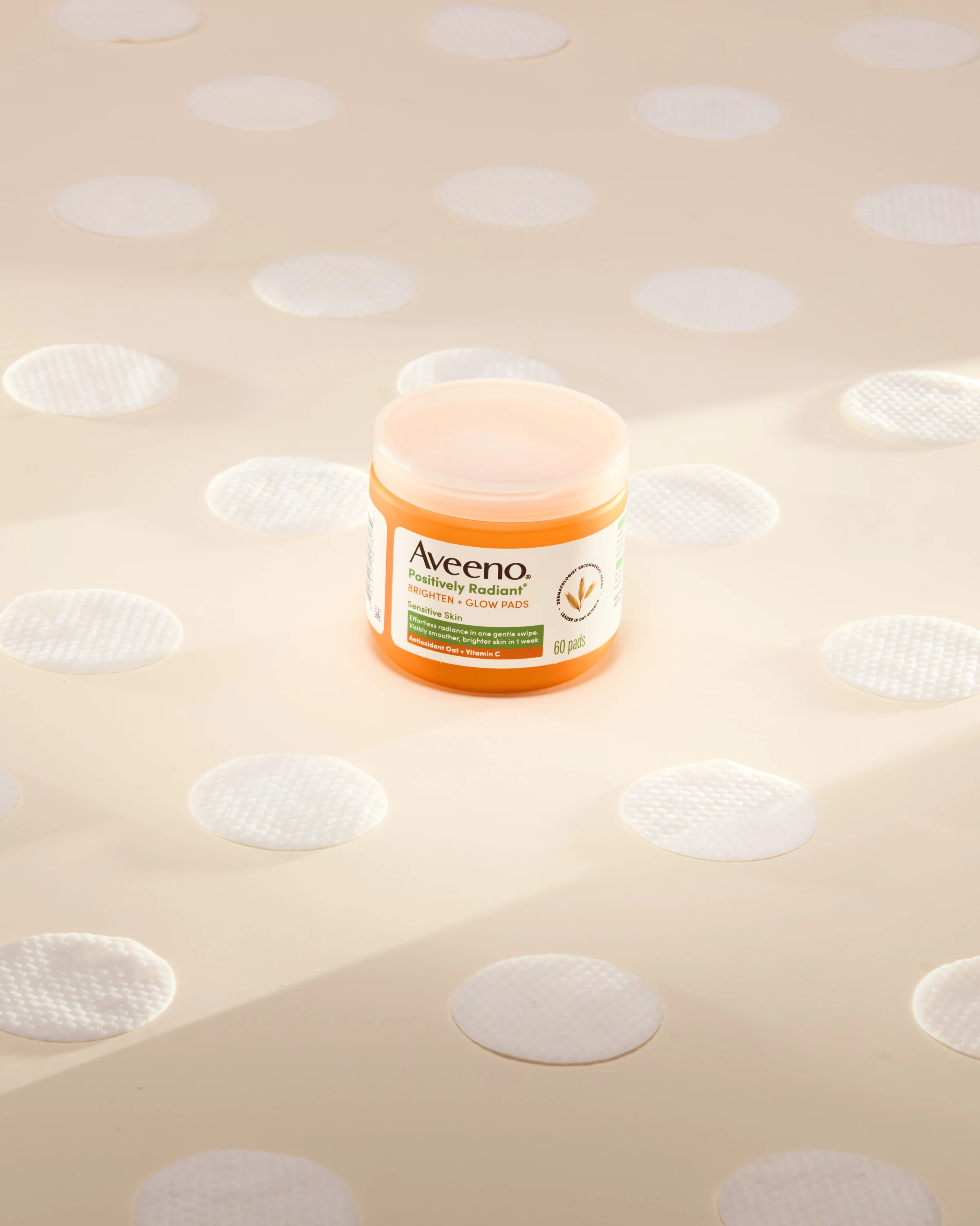 An Aveeno jar surrounded by circles of cream.