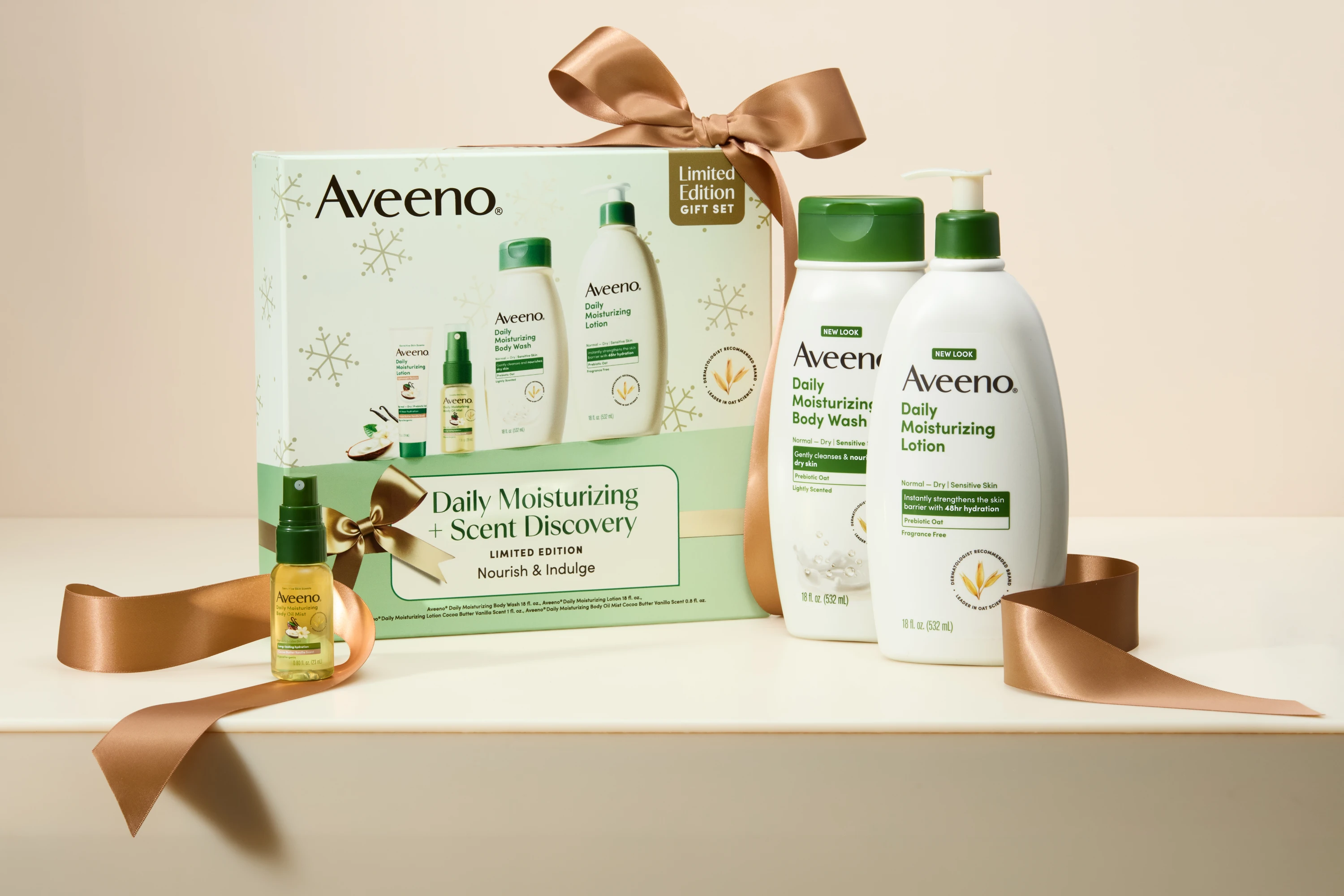 An Aveeno gift set with products and gold ribbon.