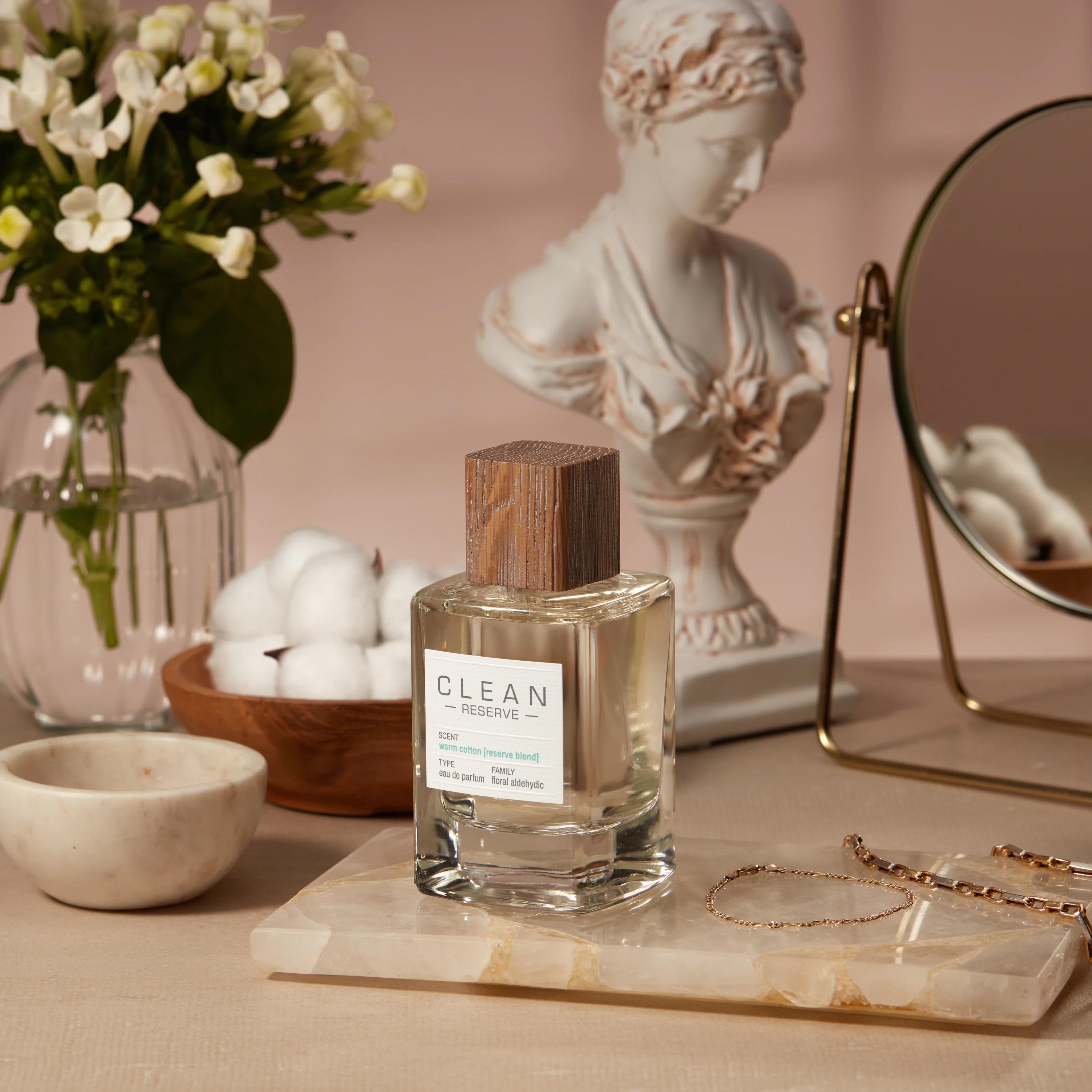 A Clean Reserve bottle on a dressing table beside a classical bust.