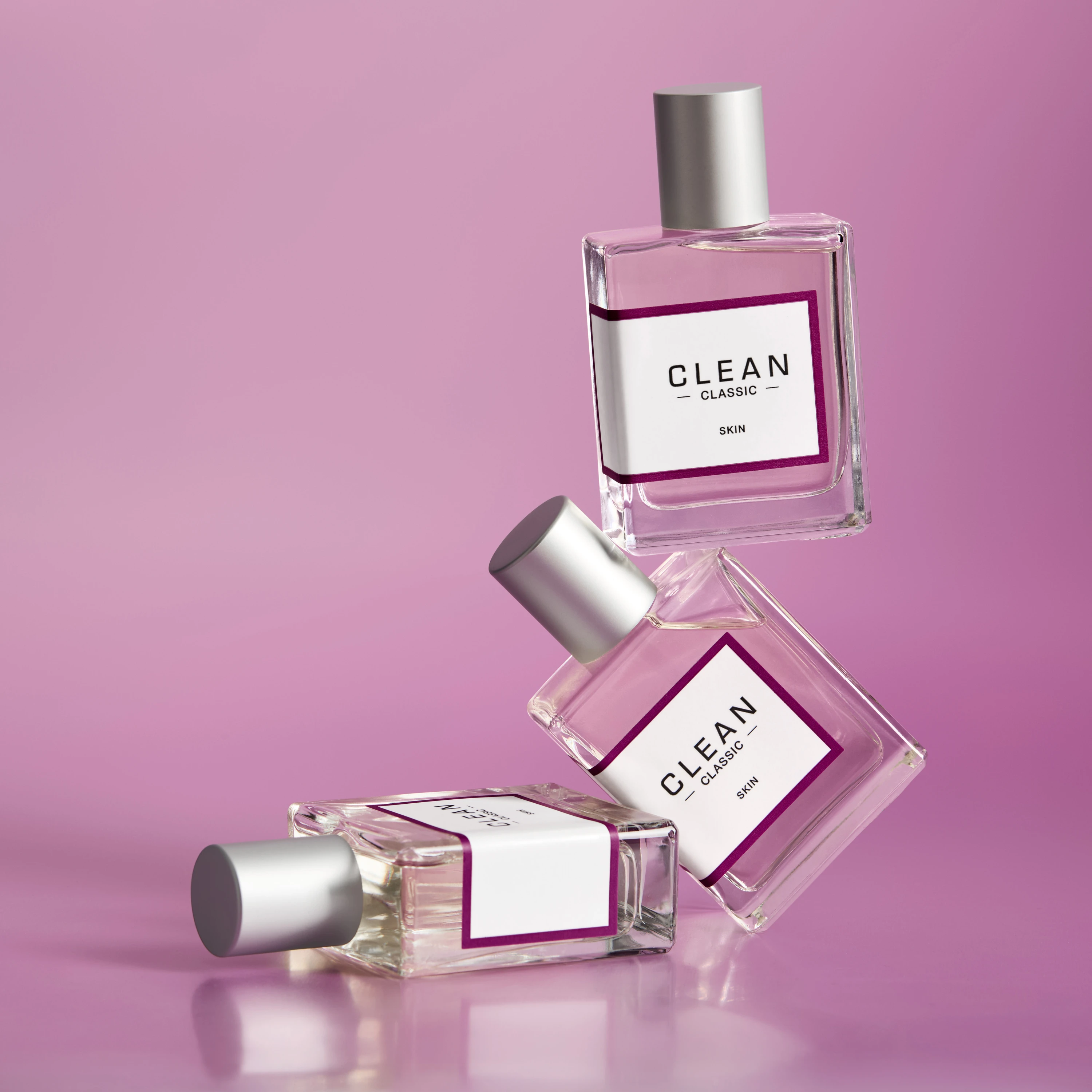 Pink Clean fragrance bottles arranged against a pink background.