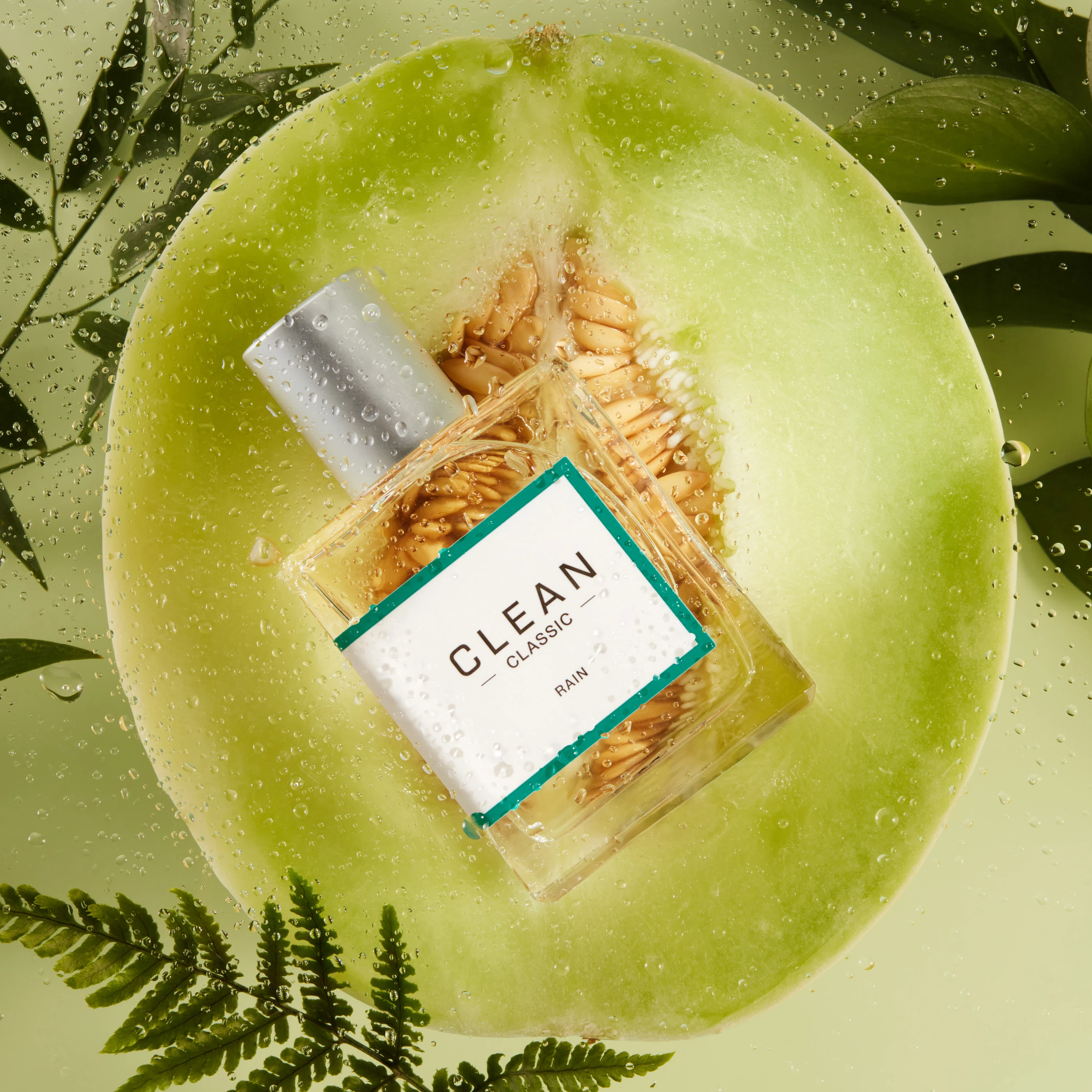 A Clean fragrance bottle resting in a halved melon.