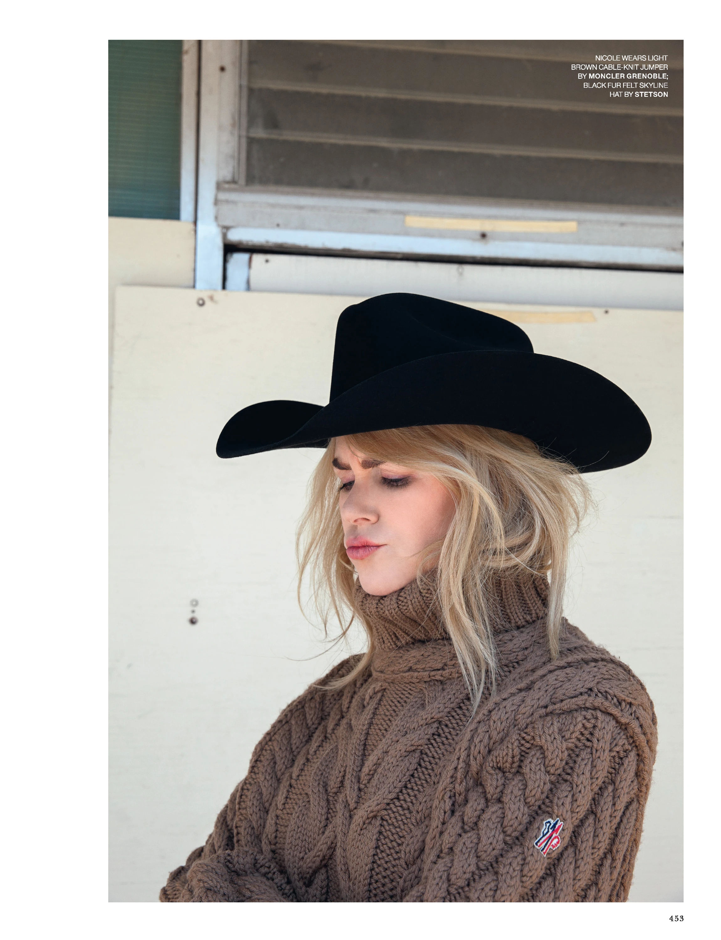 Nicole Kidman seated in a cowboy hat and chunky sweater.