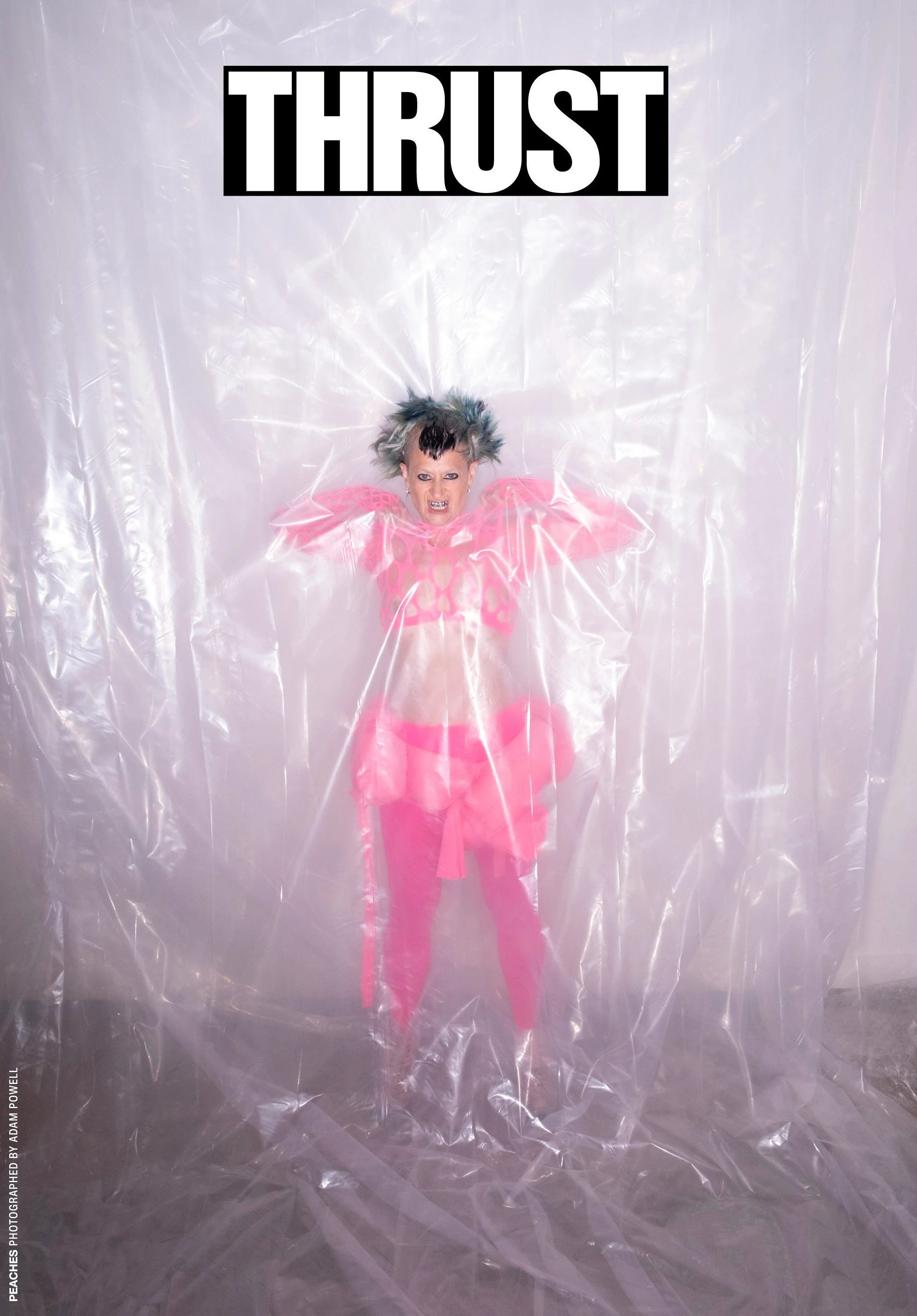 THRUST cover featuring Peaches in pink behind translucent sheeting.