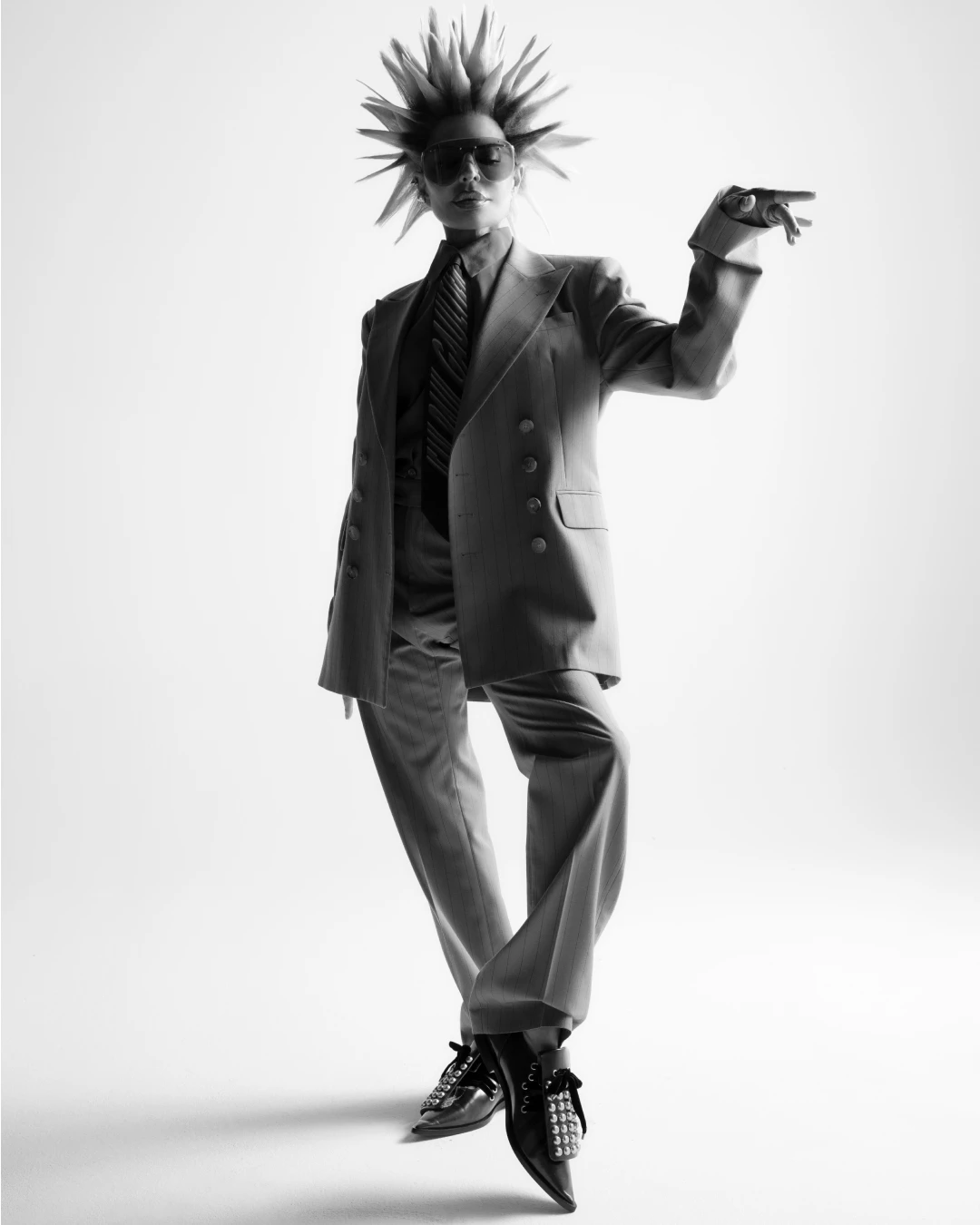 Lisa Rinna posing in a dark suit in an editorial layout.