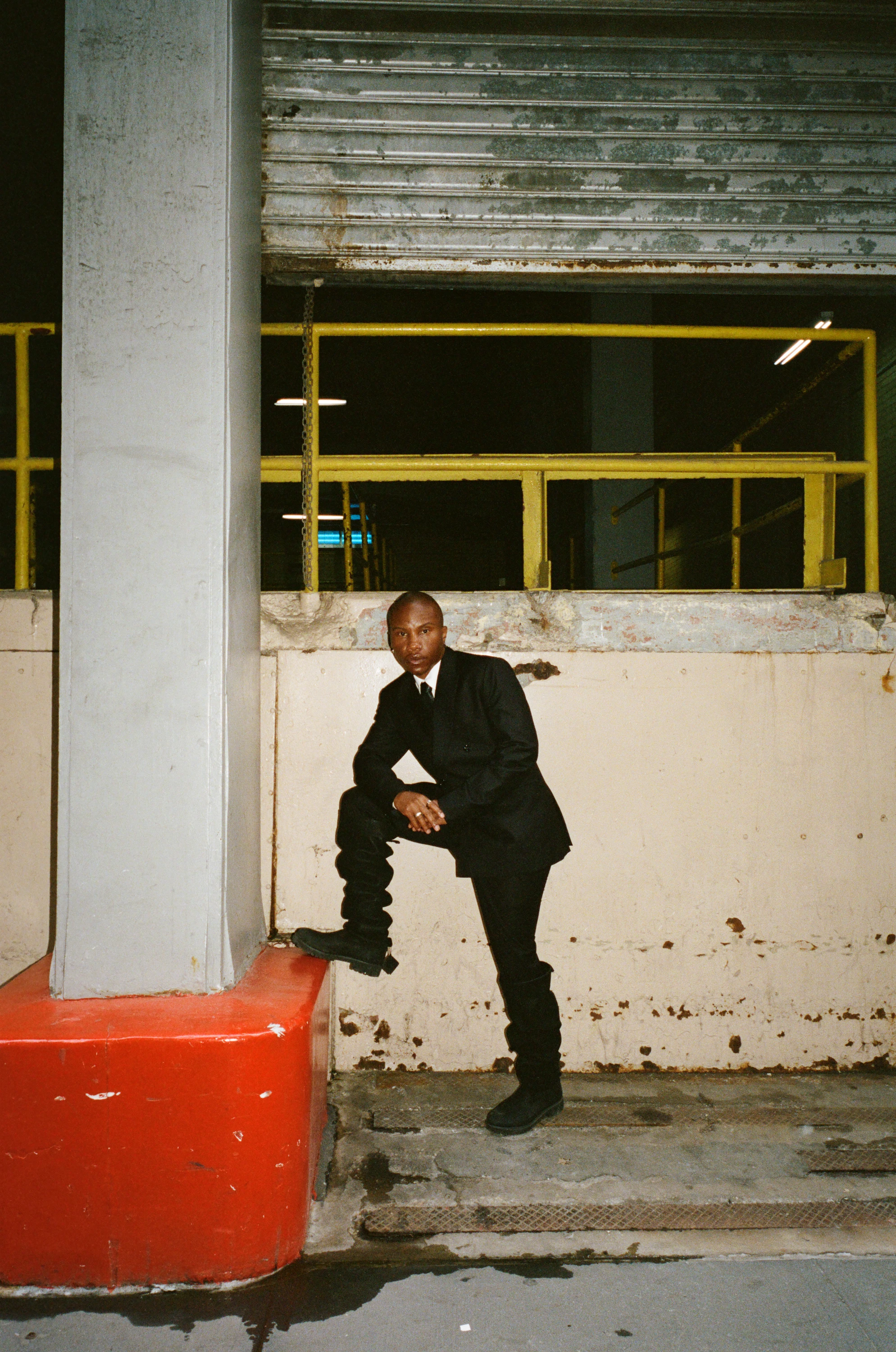 TYGAPAW posing beside an industrial loading bay.