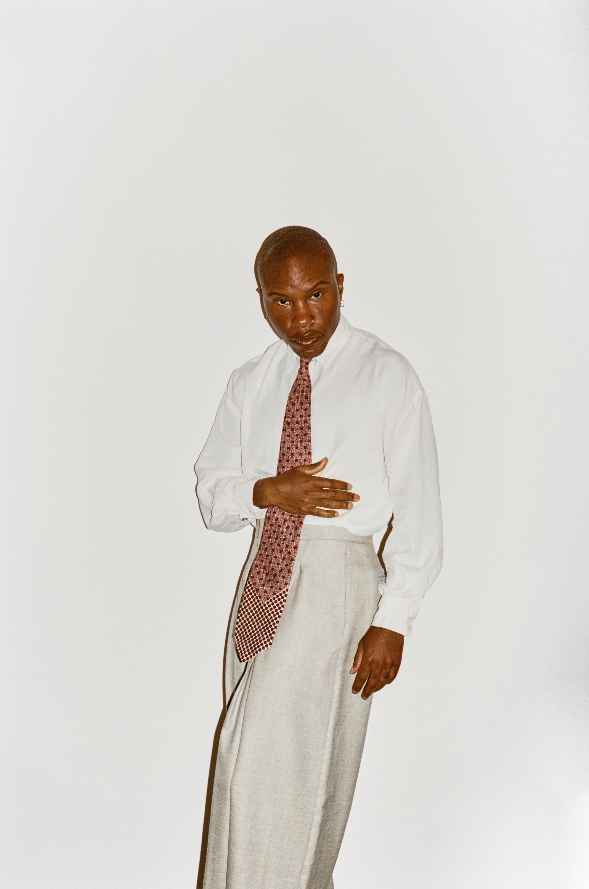 TYGAPAW posing in an open pale shirt.