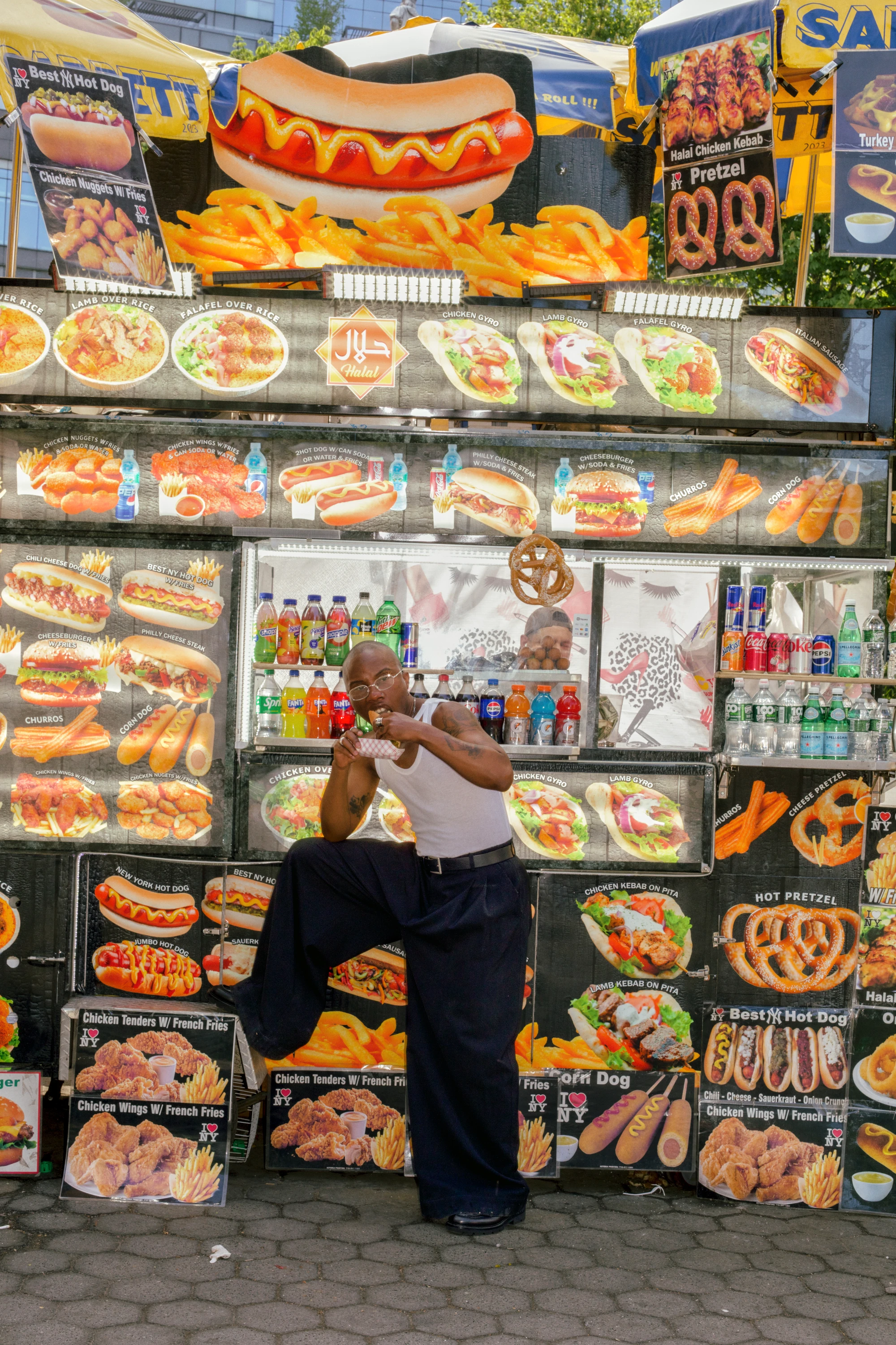 TYGAPAW posing in front of a colorful food stand.