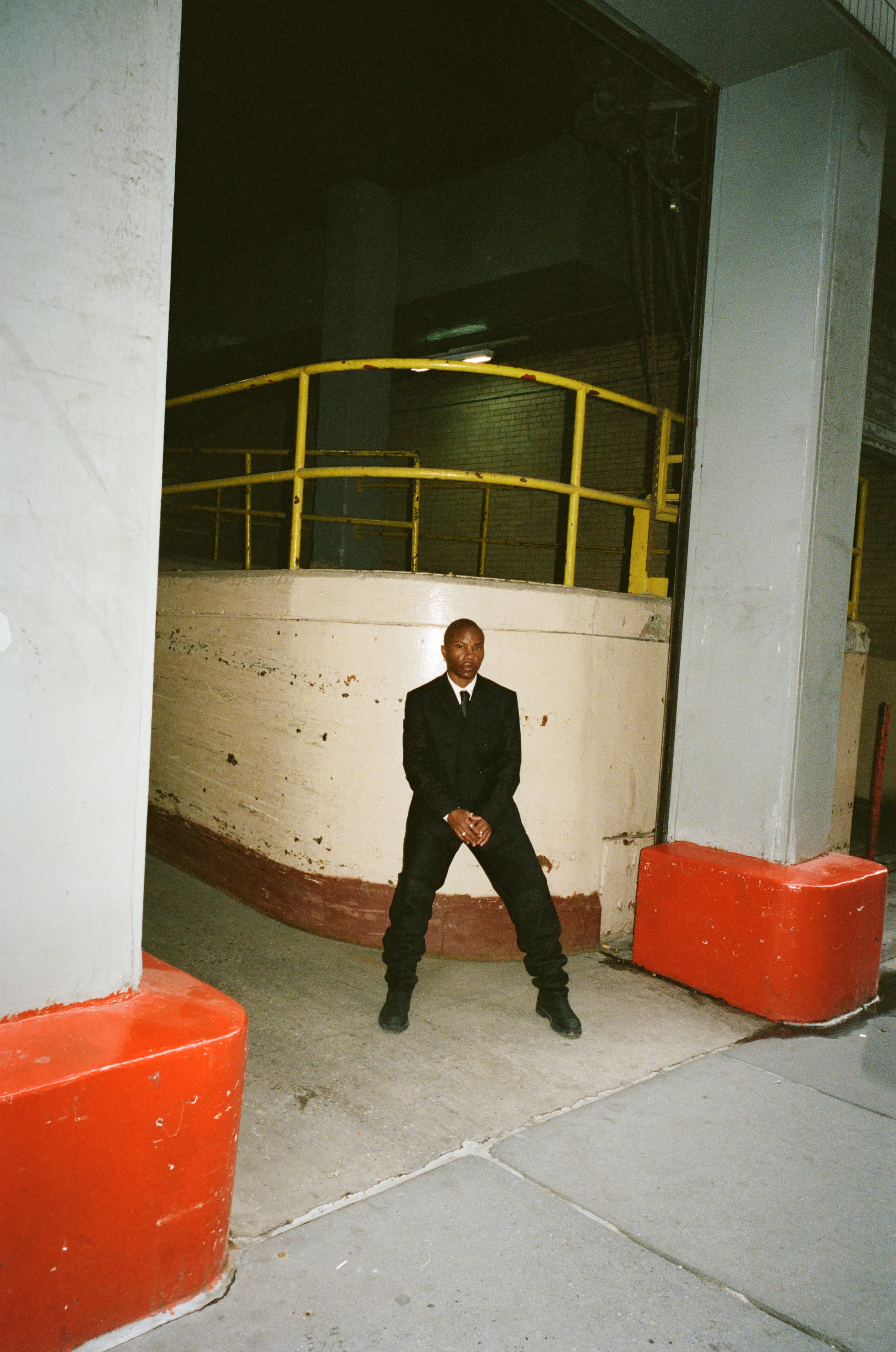 TYGAPAW standing in an industrial doorway.
