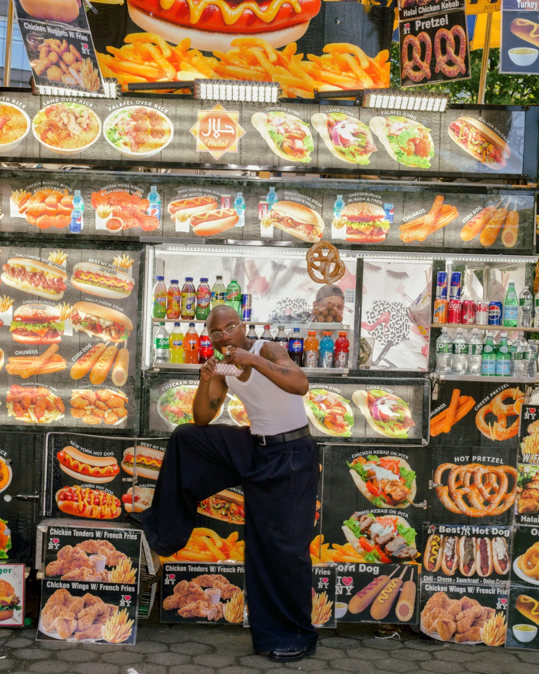 TYGAPAW editorial portrait in front of a food stand.