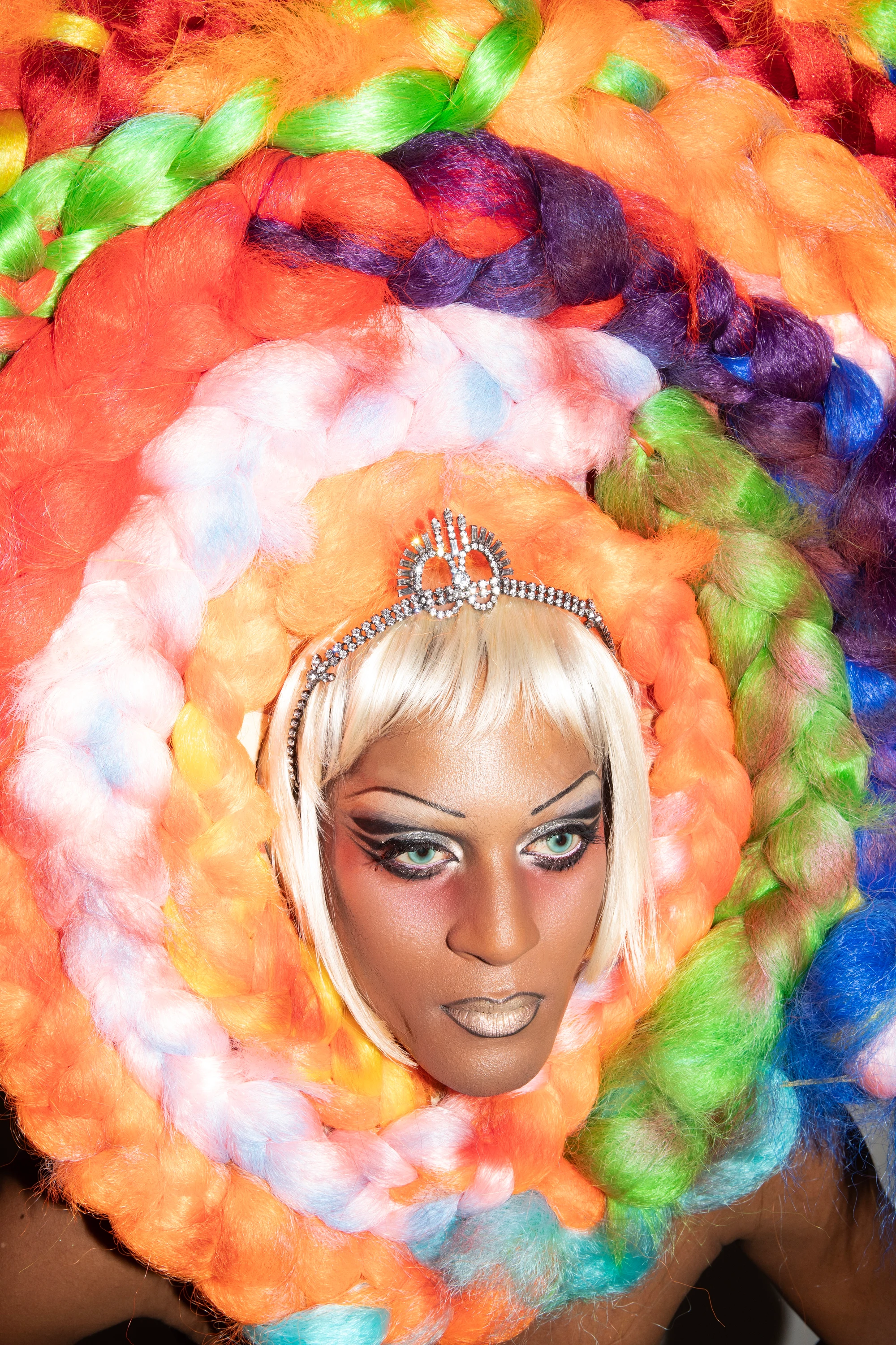 Close portrait of Richie Shazam framed by a multicolored headpiece.