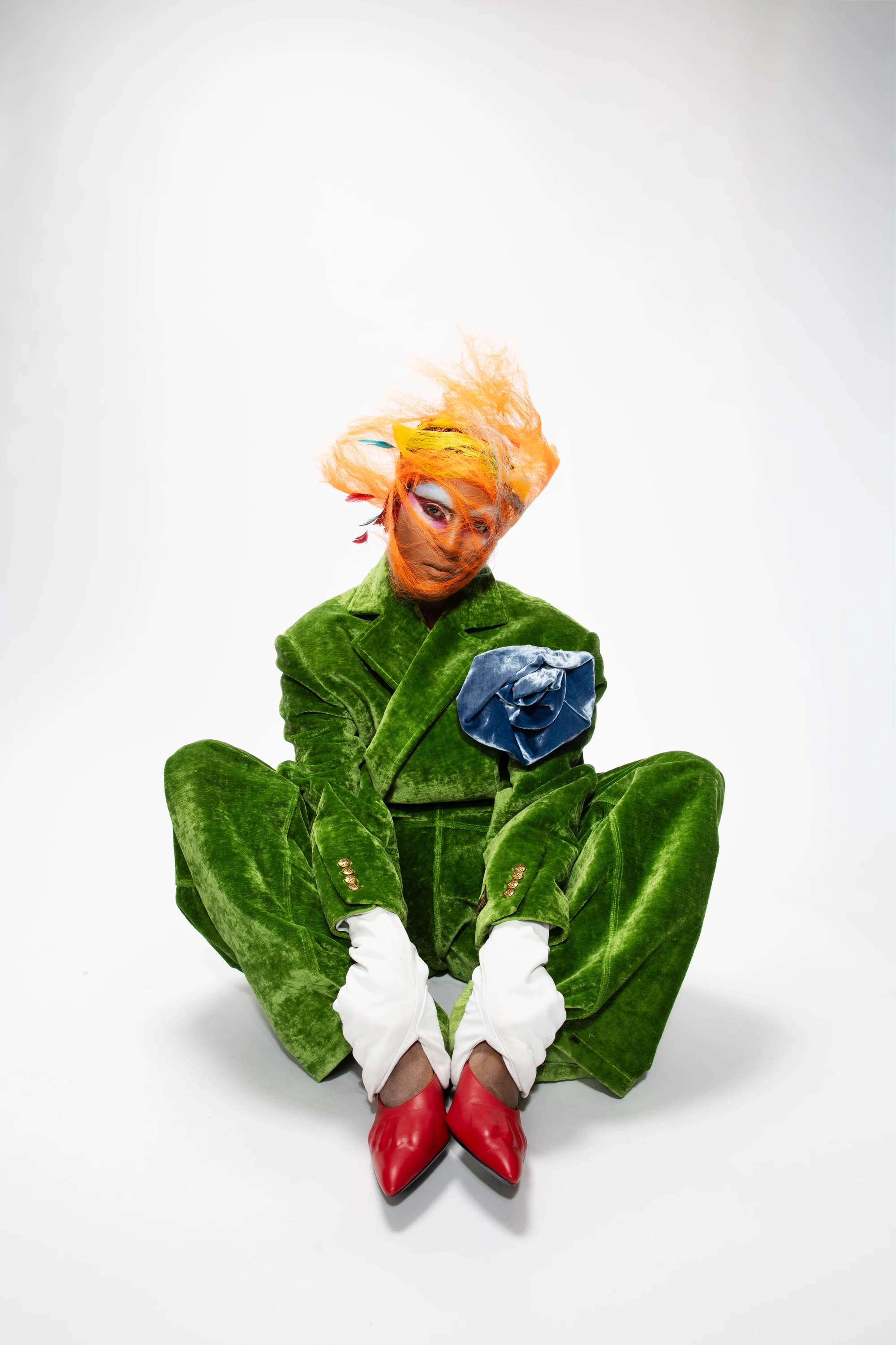 Richie Shazam crouching in a green outfit.