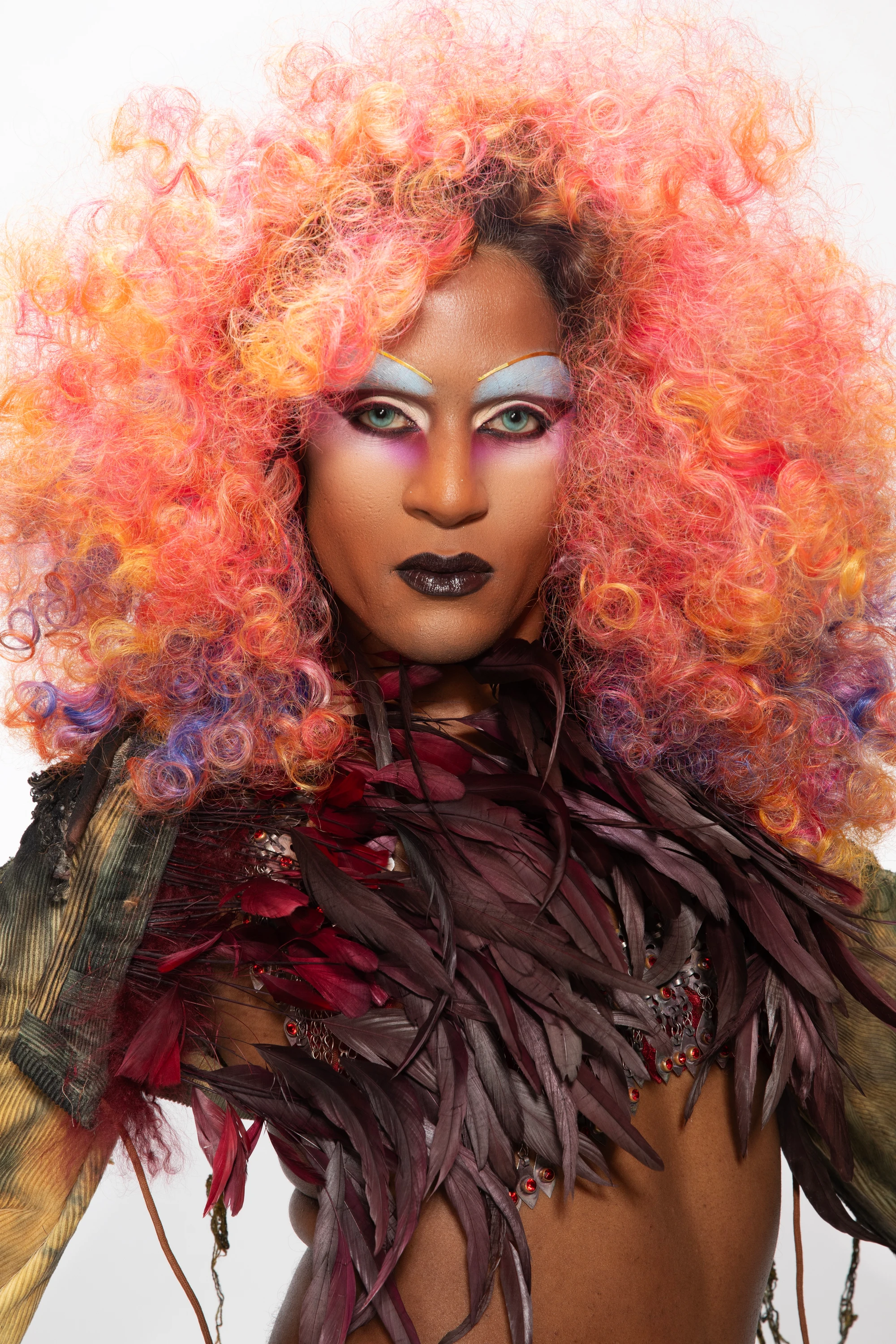 Close portrait of Richie Shazam with pink-orange hair.