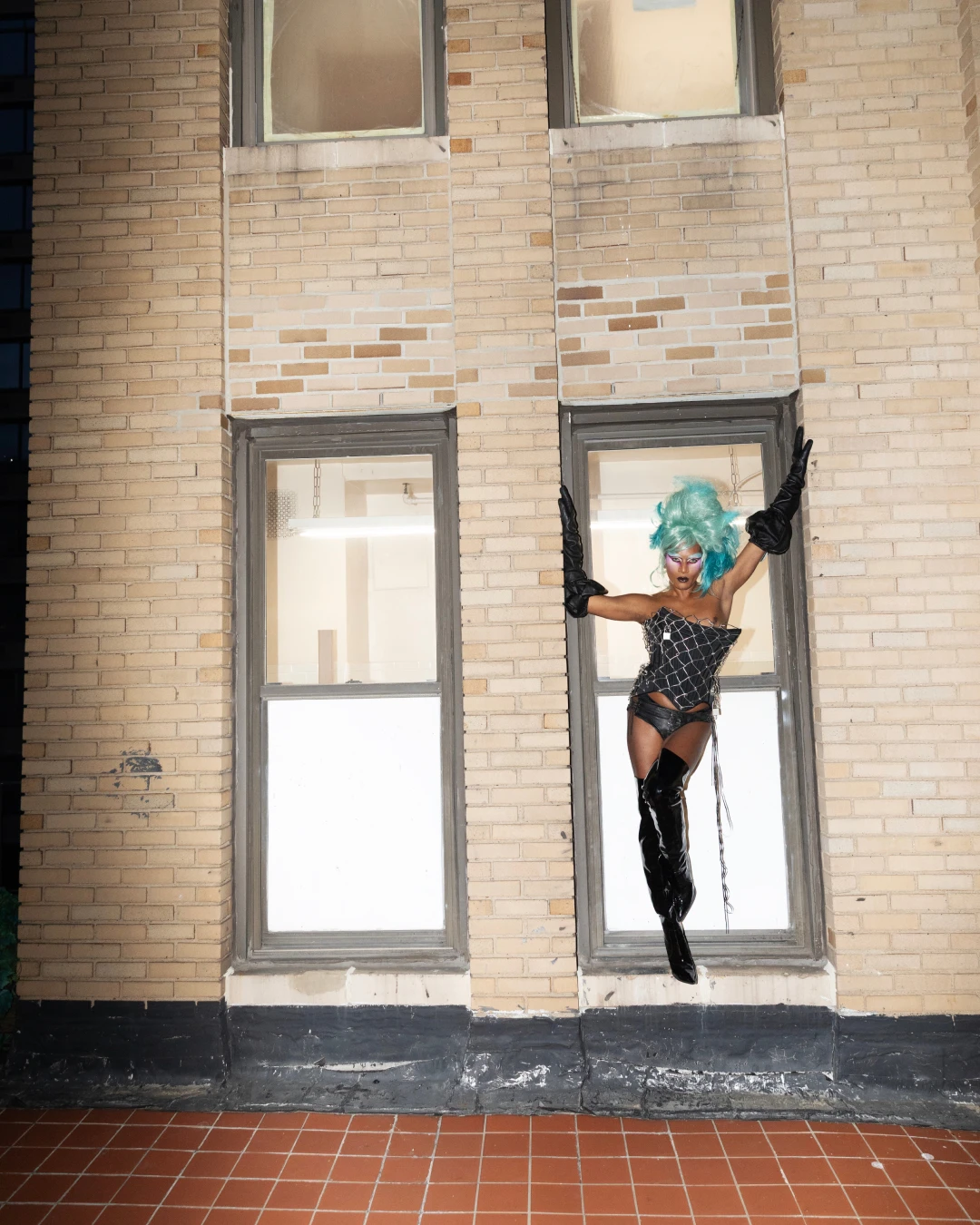 Richie Shazam posing in a doorway in an editorial layout.