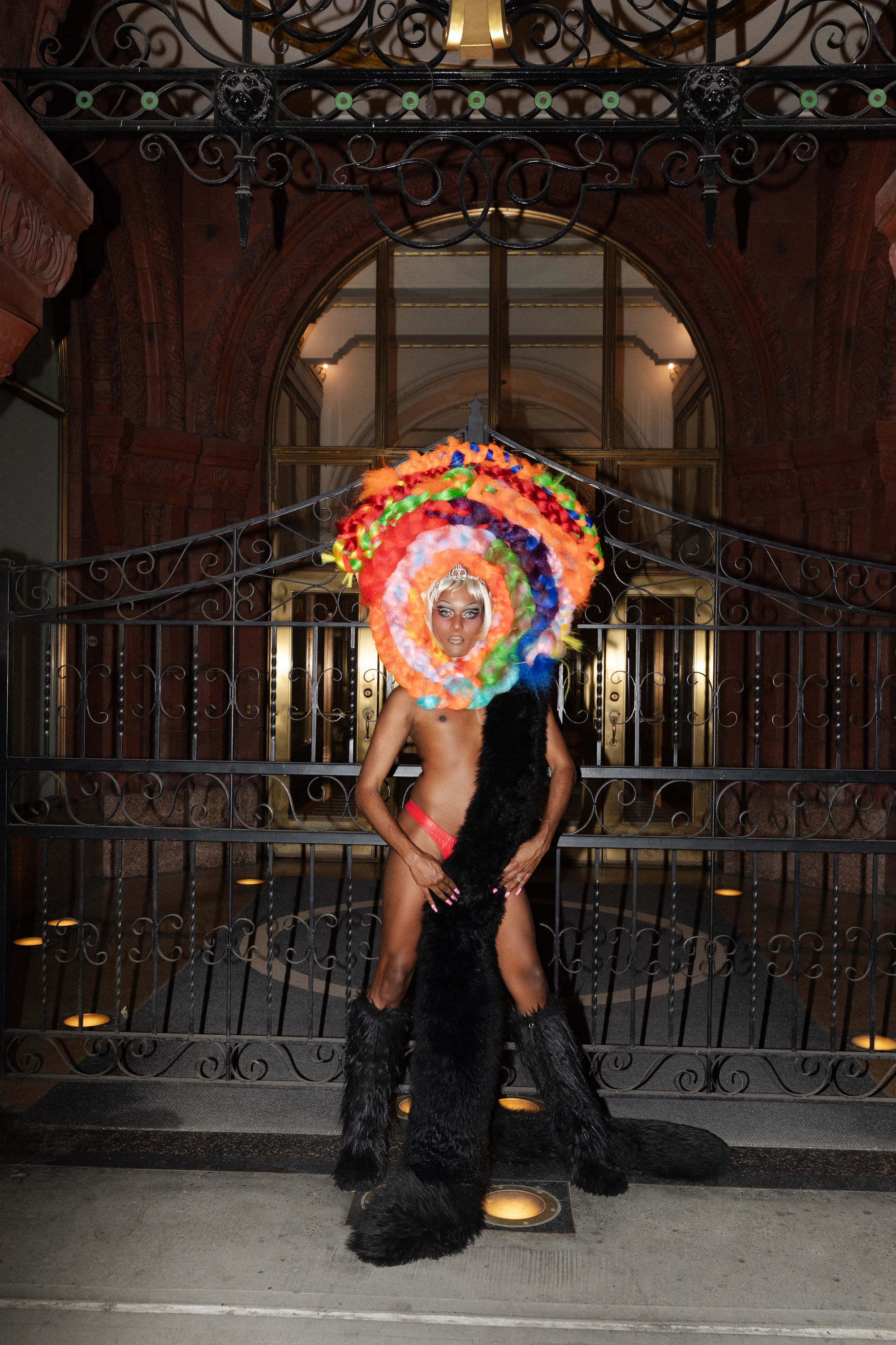 Richie Shazam posing with a colorful circular headpiece.