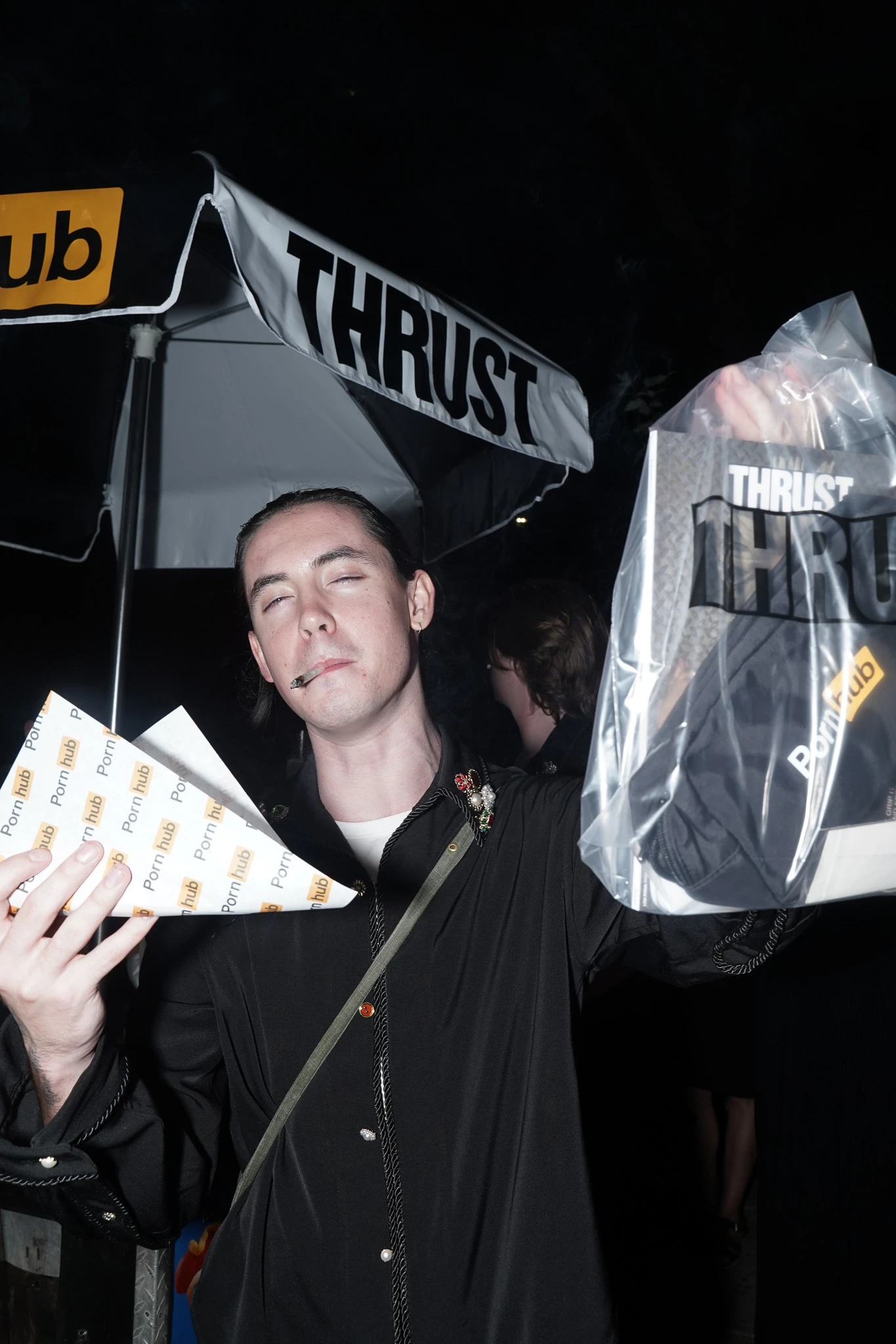 A guest holding THRUST merchandise at the launch party.