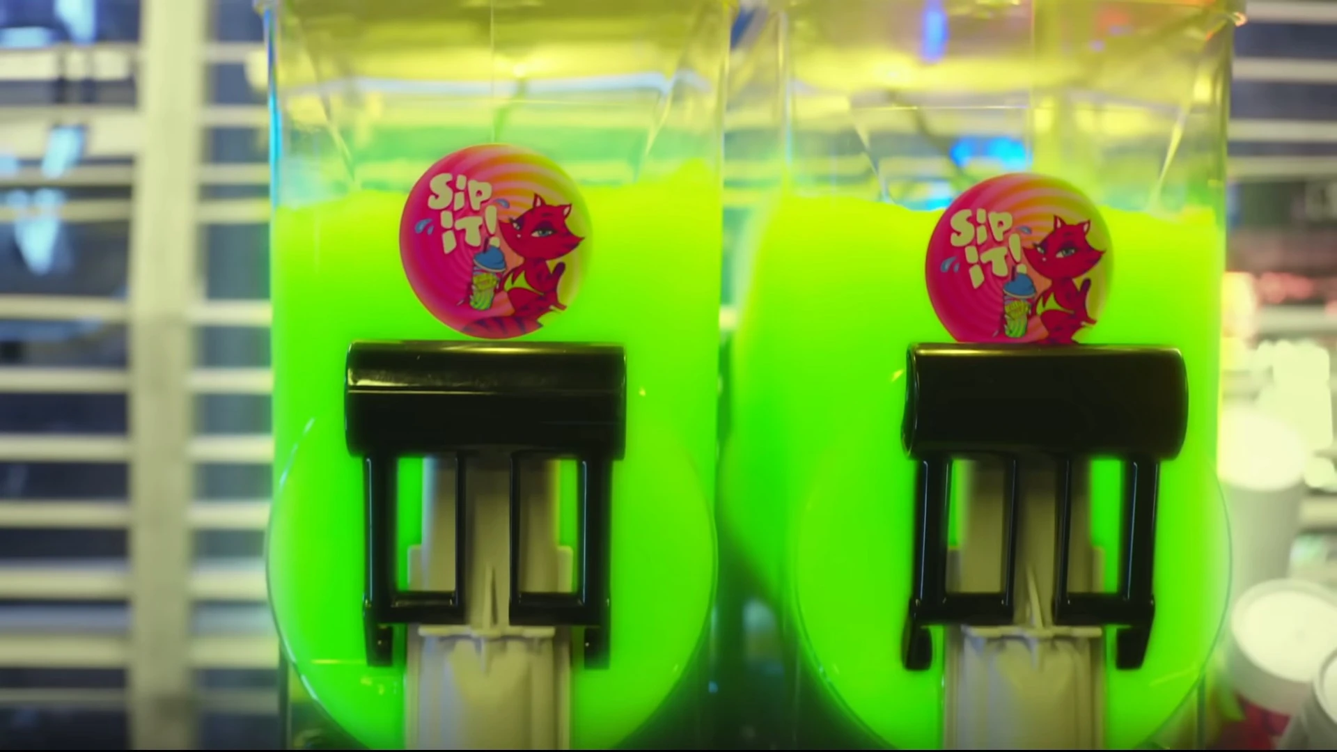 Two dispensers filled with bright green drinks.
