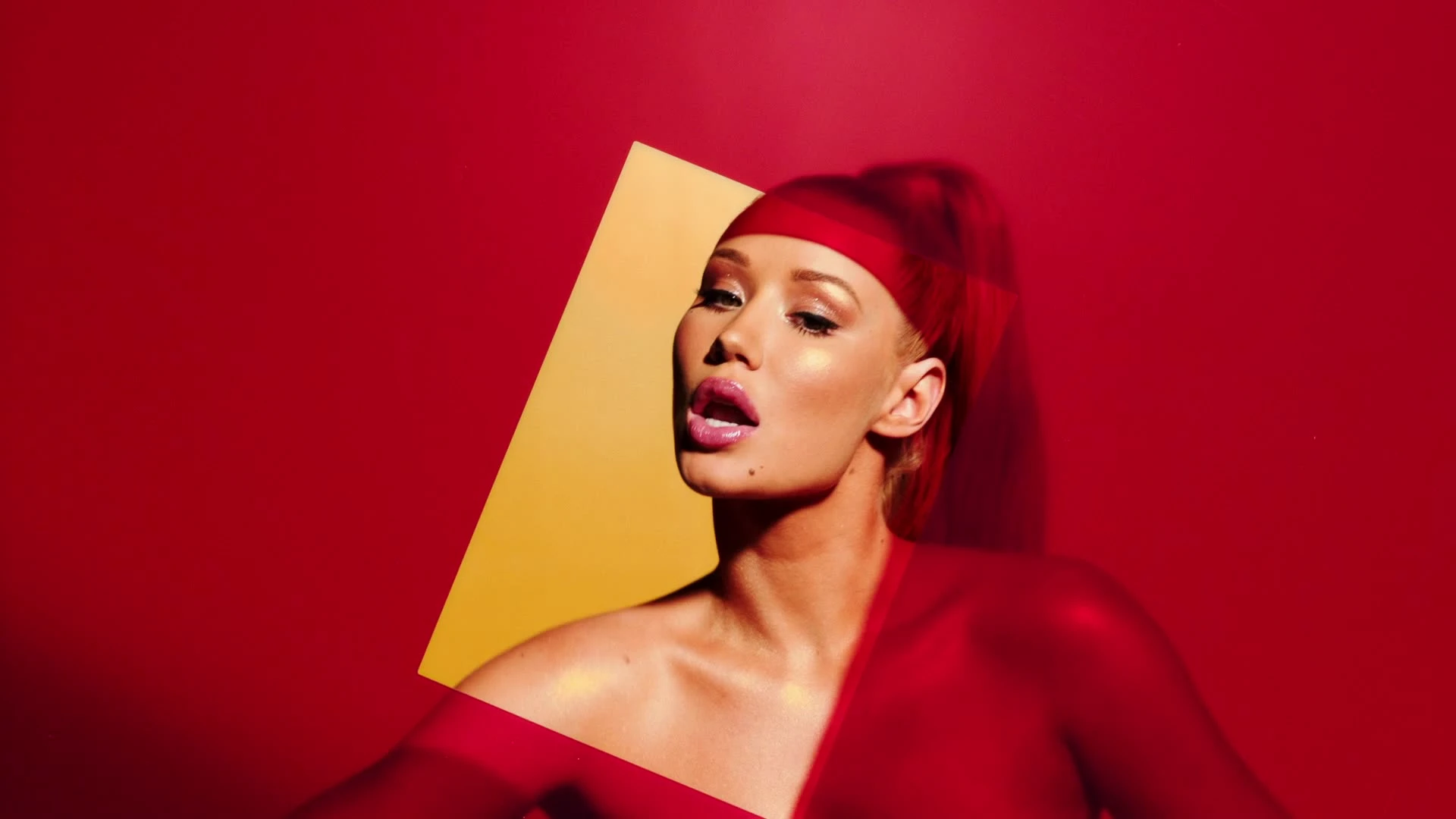 A close portrait framed by a red-and-yellow cutout.