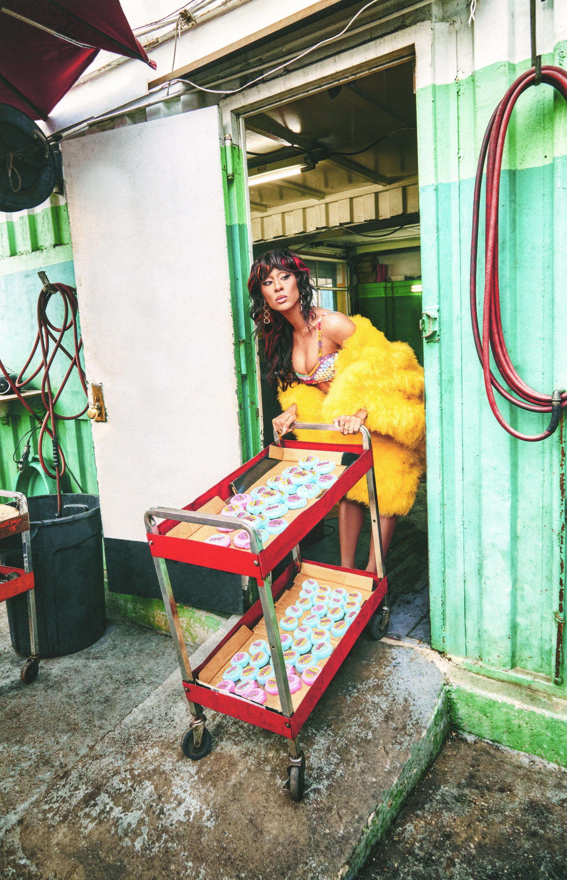 Michaela Jaé posing at the entrance of a shop.