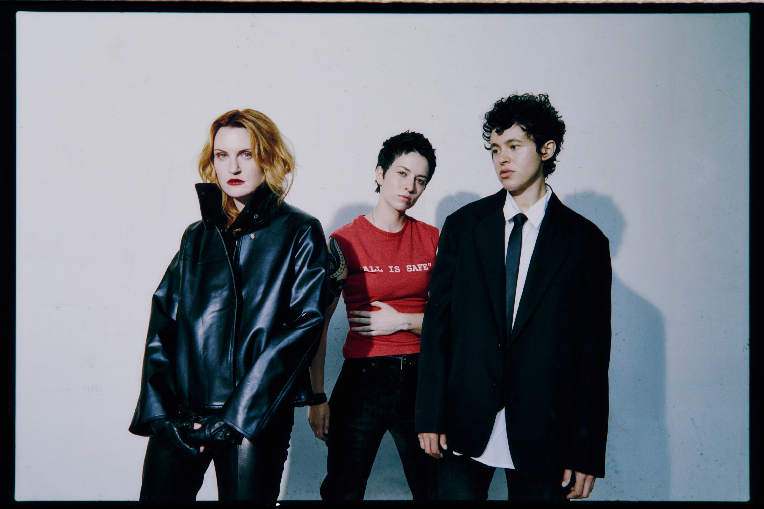 MUNA standing together against a pale backdrop.
