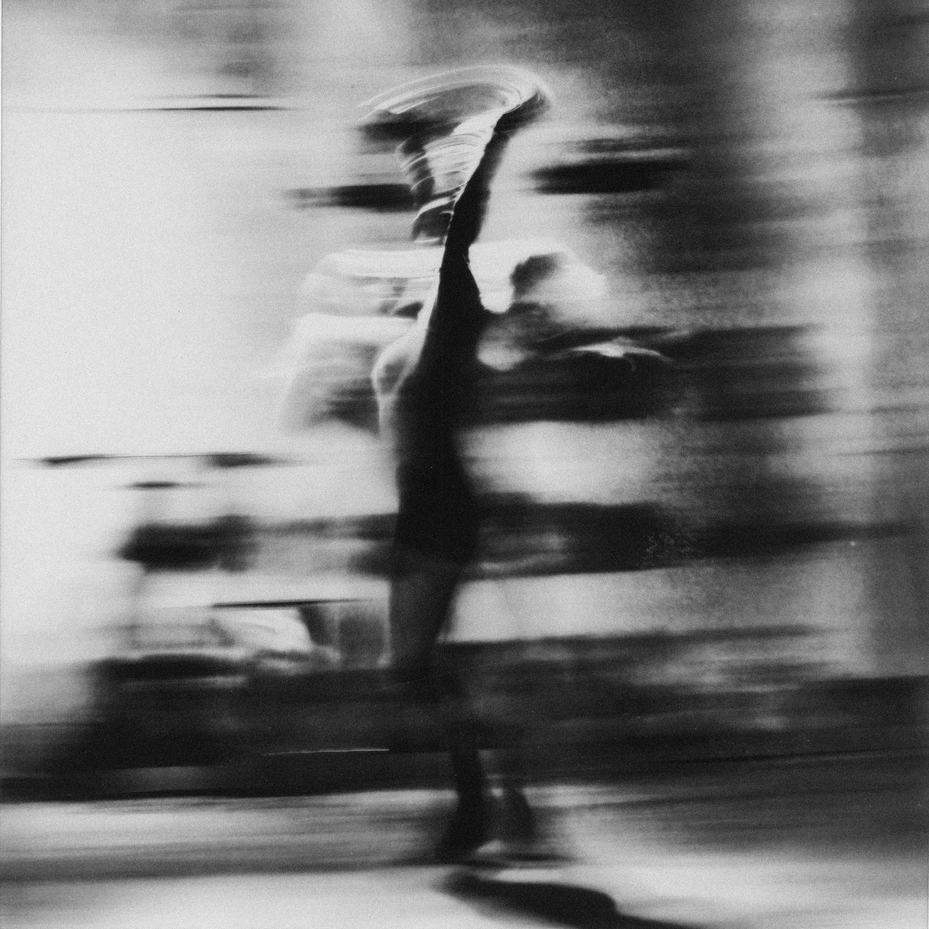 Motion-blurred black-and-white performance still.