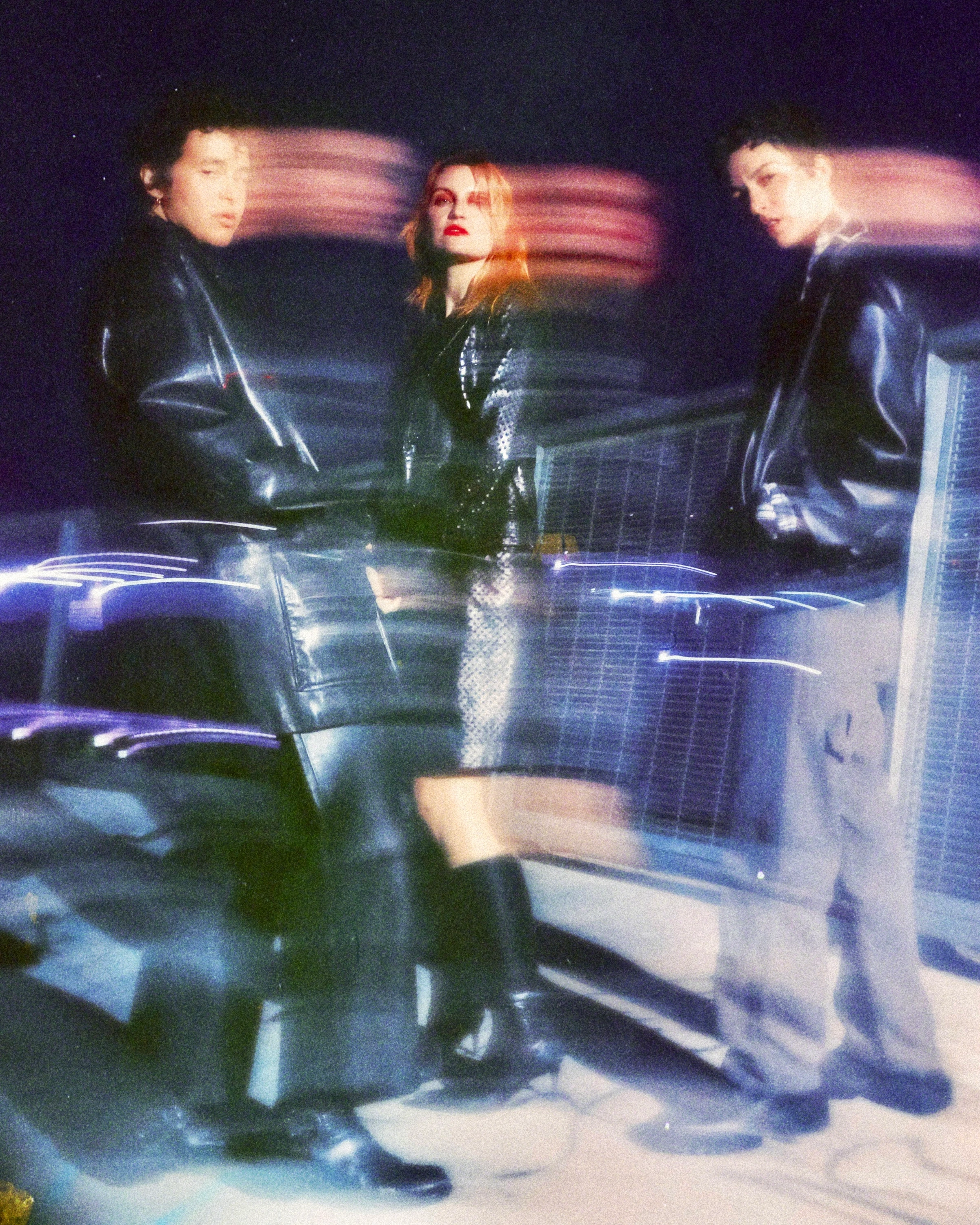 Motion-blurred portrait of MUNA seated together.