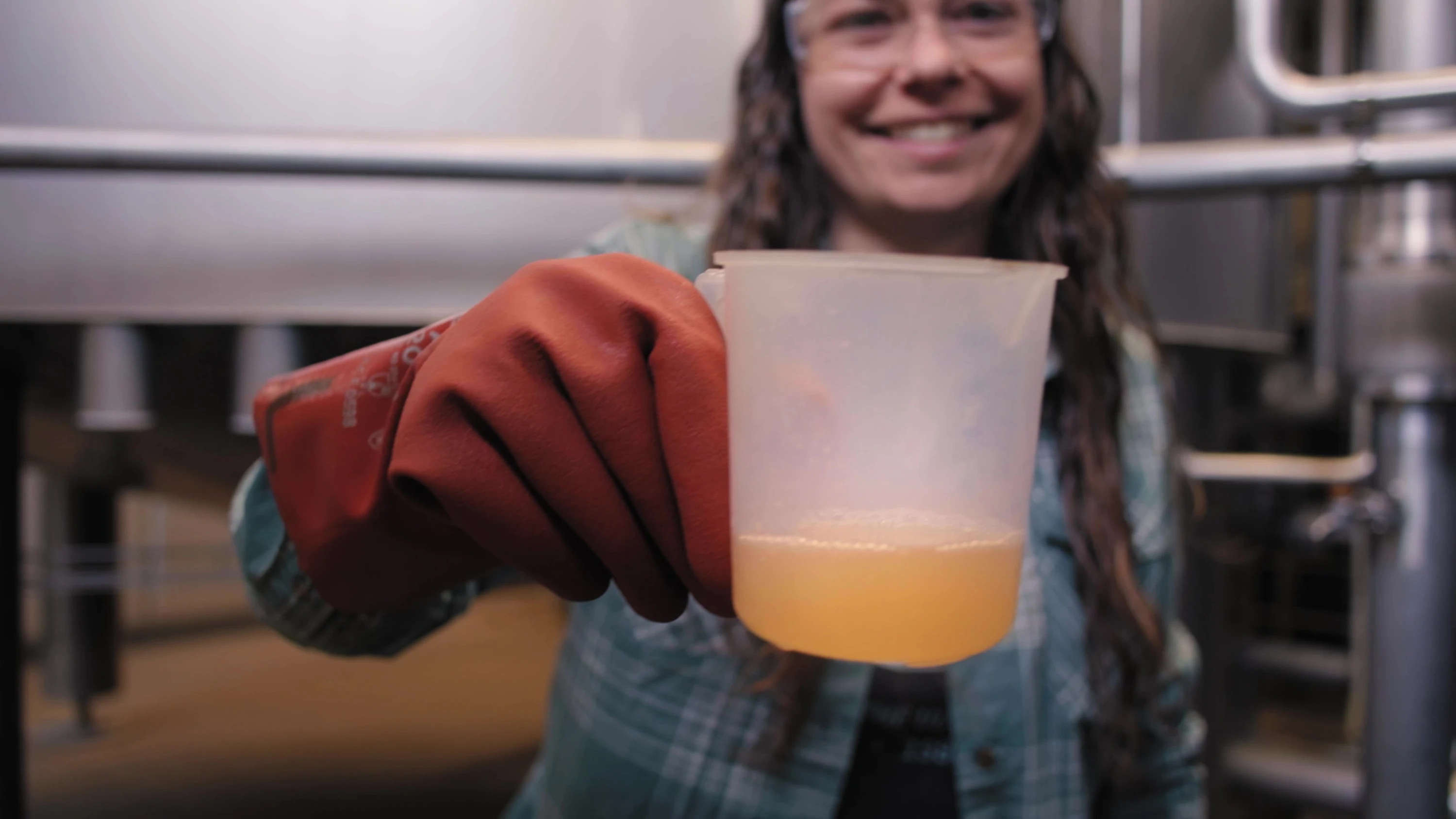 A worker holding a measuring jug of liquid.