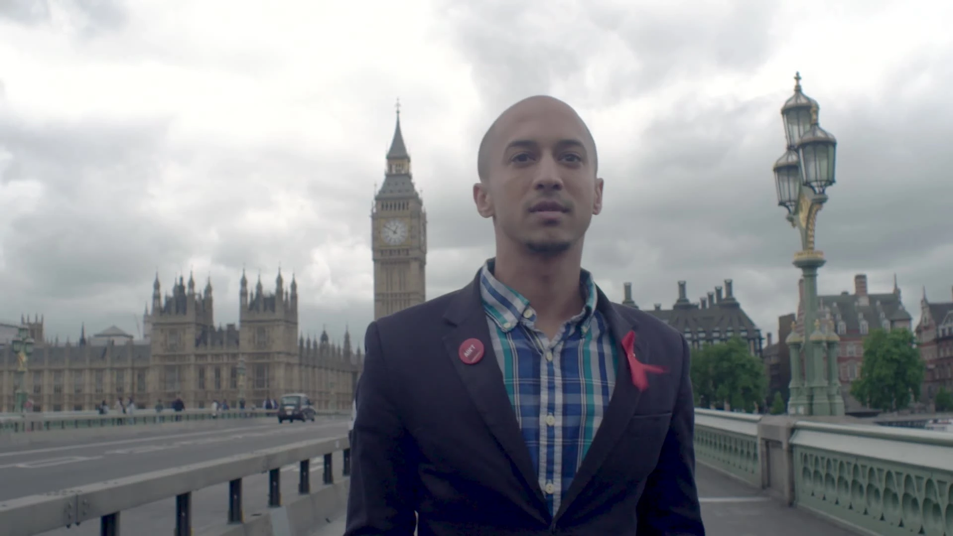 A person standing on a bridge with the Houses of Parliament behind them.