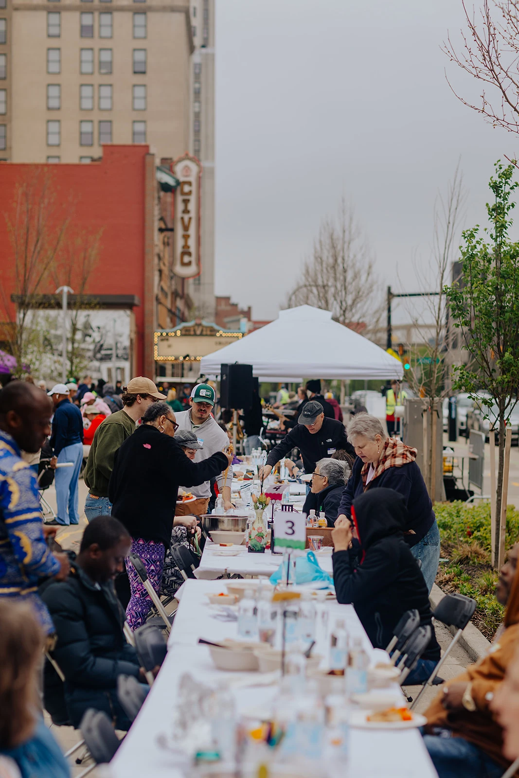 A long line of dining tables stretching down an Akron street.