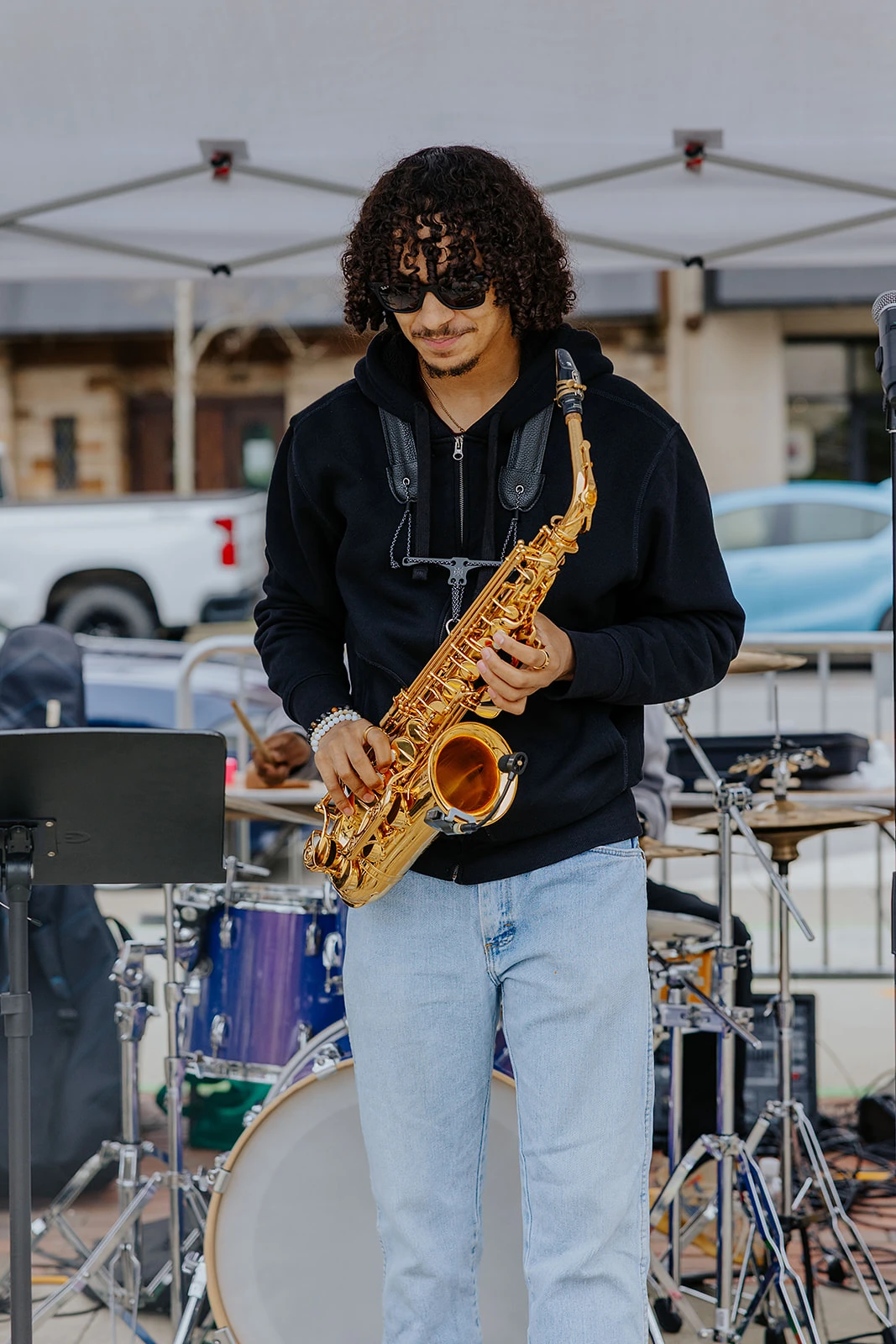 A saxophonist performing outdoors.