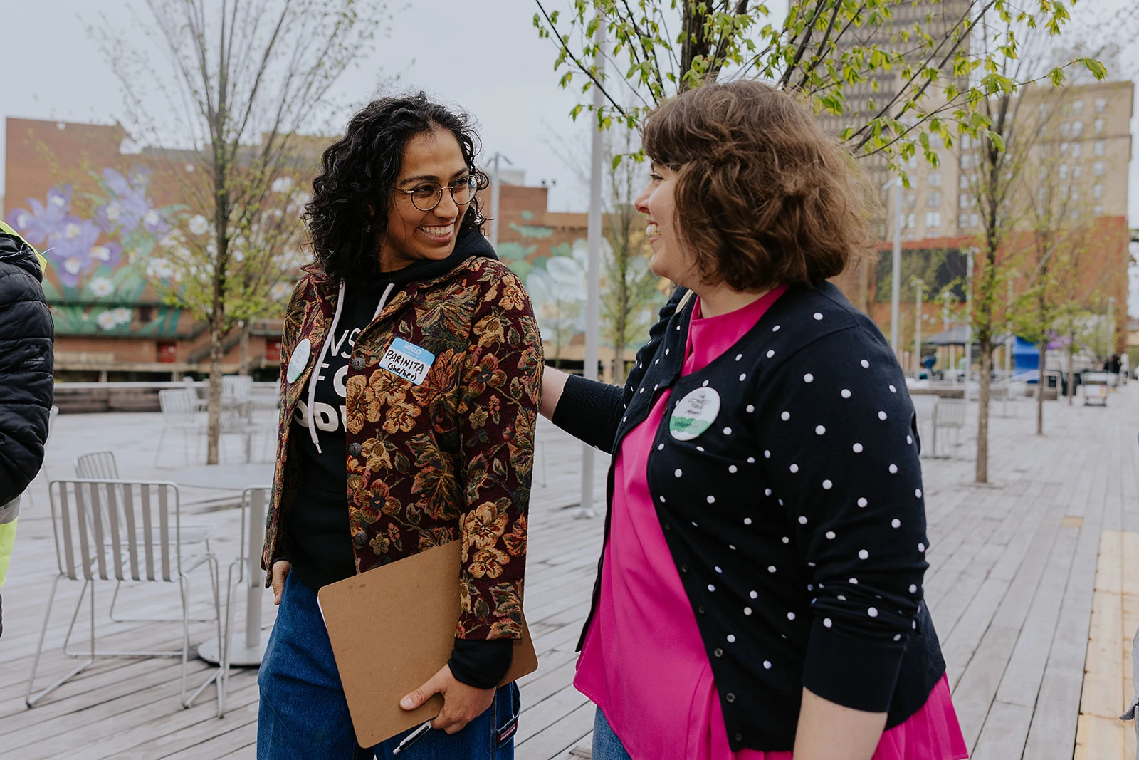 Two participants talking on a downtown street.