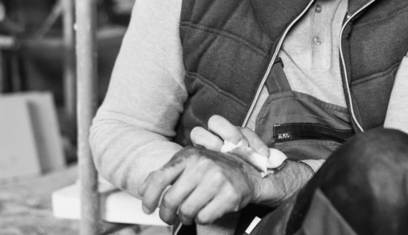 Worker in a workshop holding an injured hand