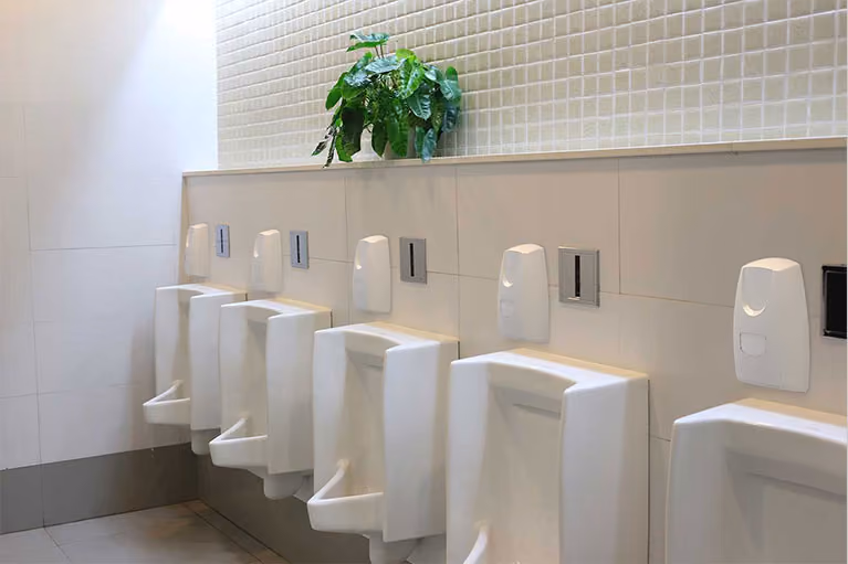 Commercial washroom fitted with wall-mounted Vectair hygiene and aircare dispensers