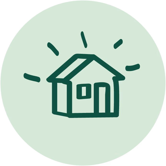 Simple dark green house icon with light rays on a light green circular background.