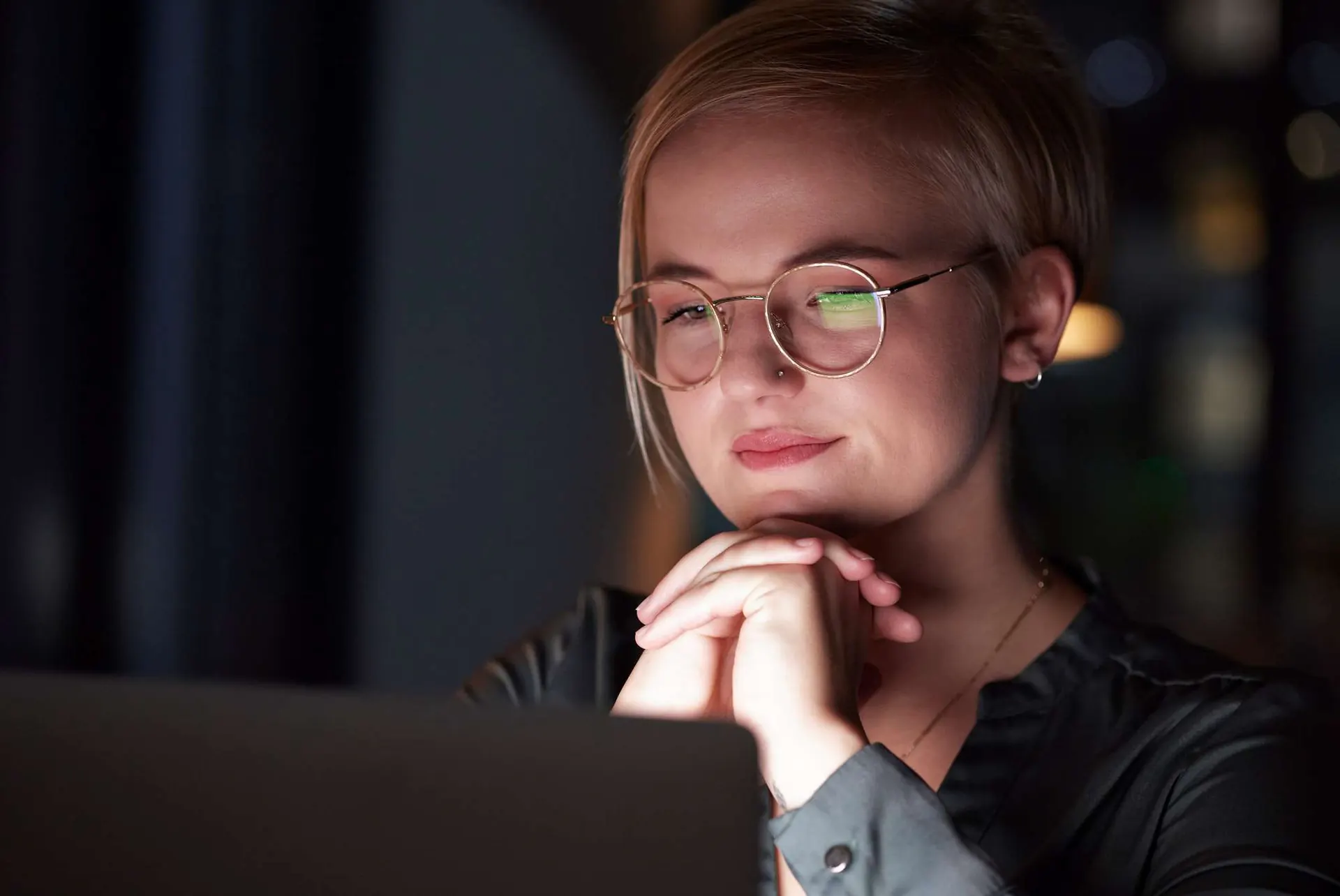 Night, laptop and reflection with woman in office for overtime, planning and thinking. Glasses, tec