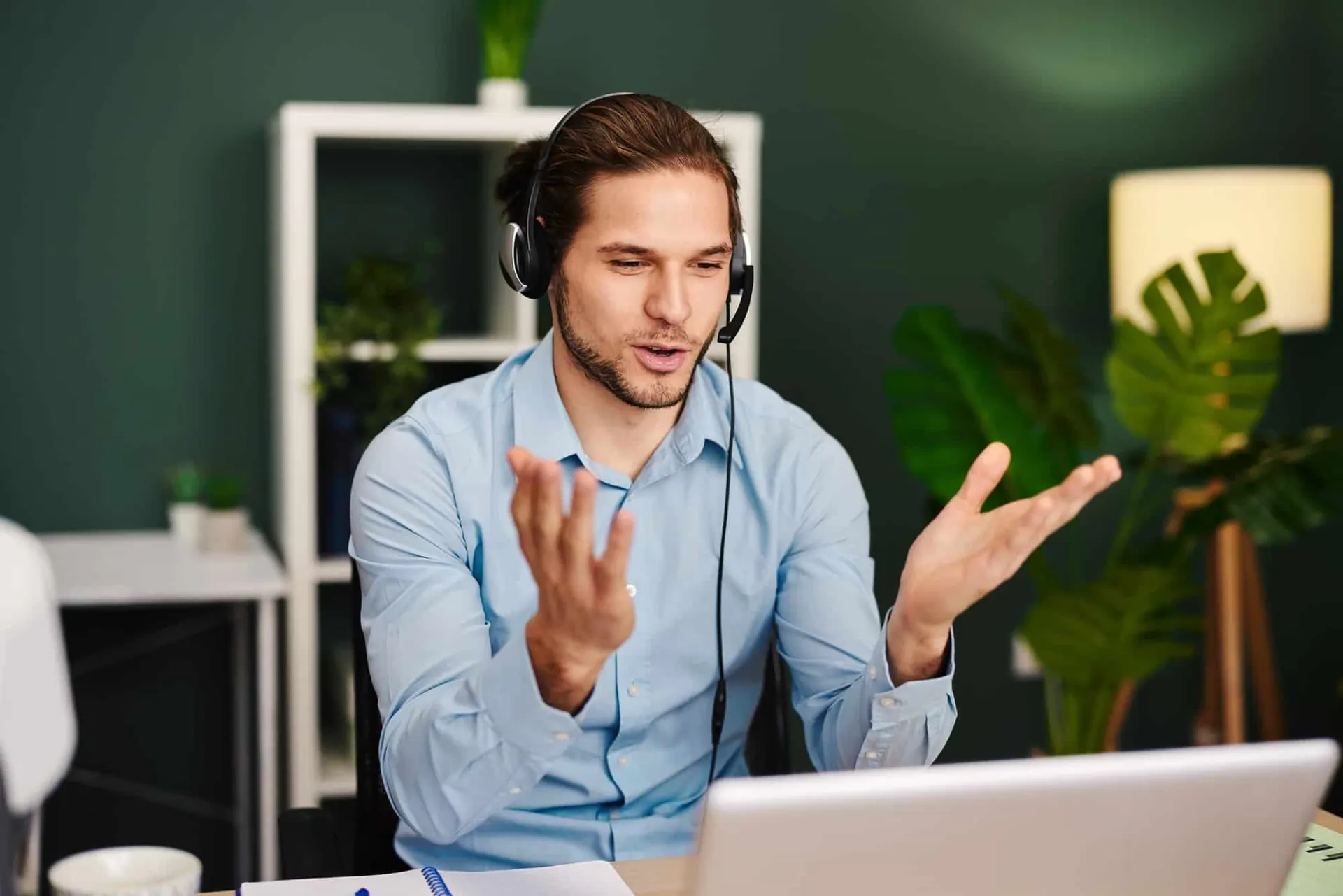Young man working as customer support in the office