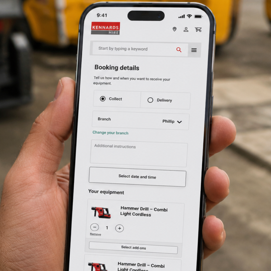 Hand holding a smartphone displaying Kennards Hire booking details page with options to collect or deliver equipment, select branch, add instructions, and view equipment including a cordless hammer drill.