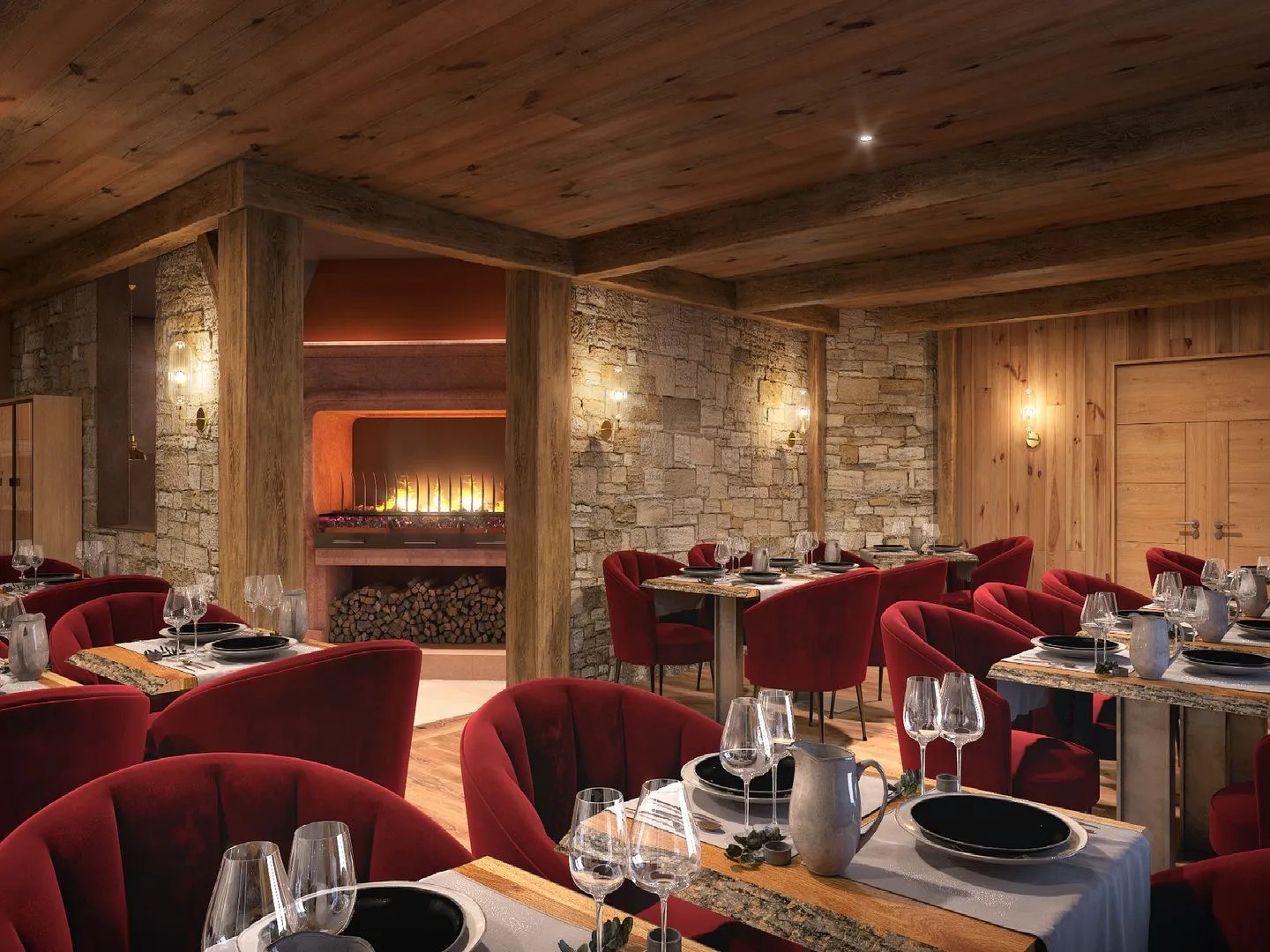 Salle de restaurant du Diamond Rock à Tignes, avec fauteuils rouges, tables dressées et cheminée dans un mur de pierre.