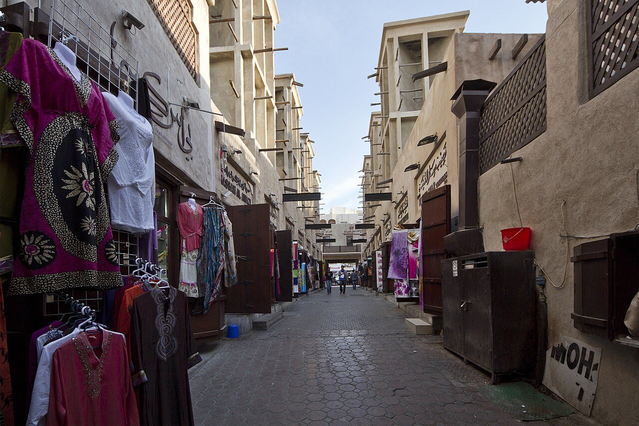 Ruelle du souk de Bur Dubai, échoppes de vêtements et maisons de pierre à moucharabiehs
