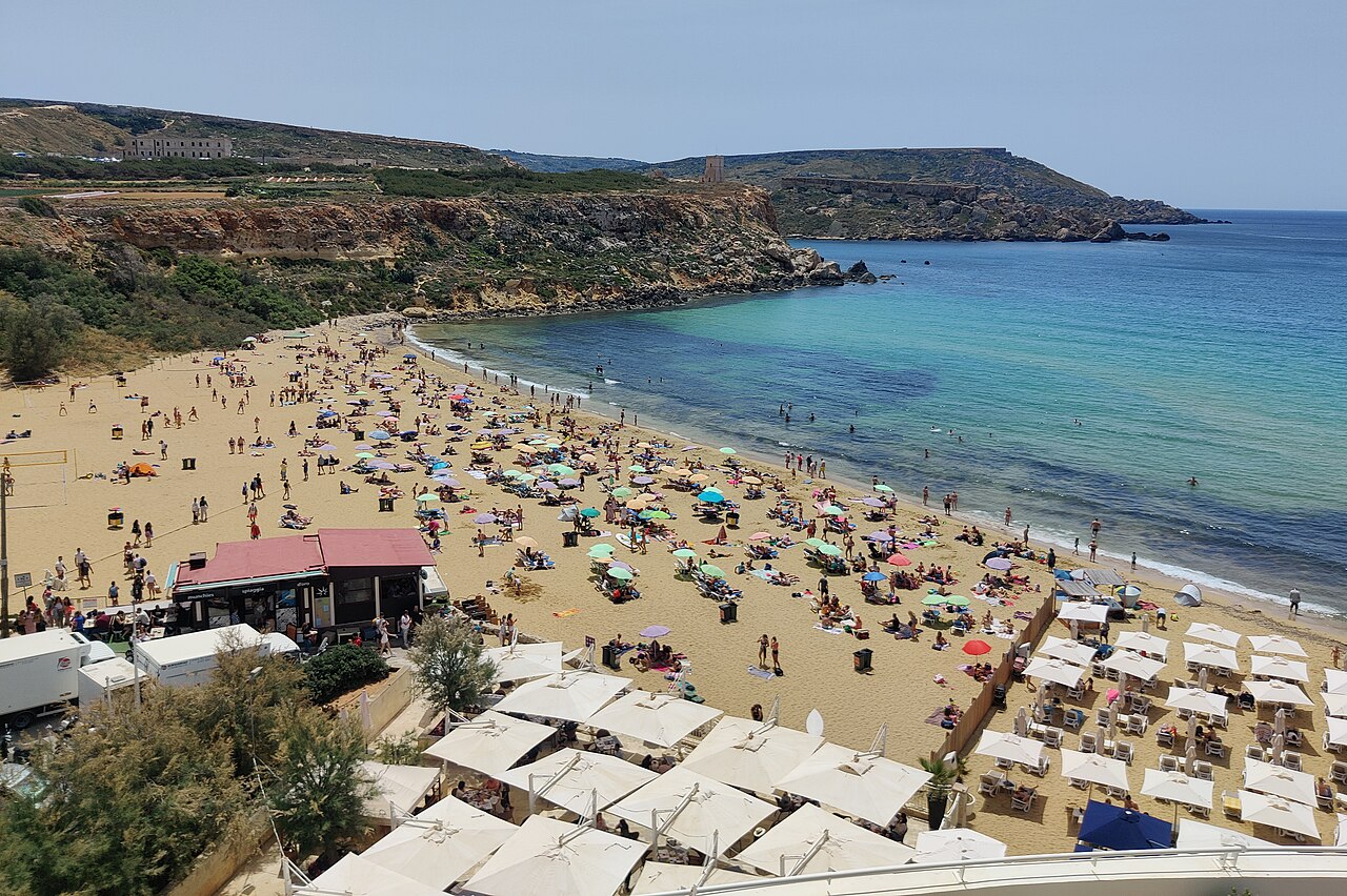 Le sable, les parasols et la mer de Golden Bay, sur la côte nord-ouest de Malte.